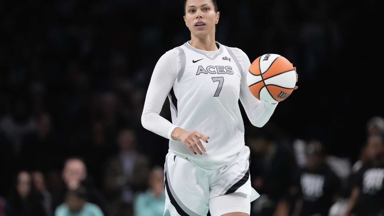 FILE - Las Vegas Aces' Alysha Clark (7) looks to pass during the second half of a WNBA basketball semifinal game against the New York Liberty, Oct. 1, 2024, in New York.