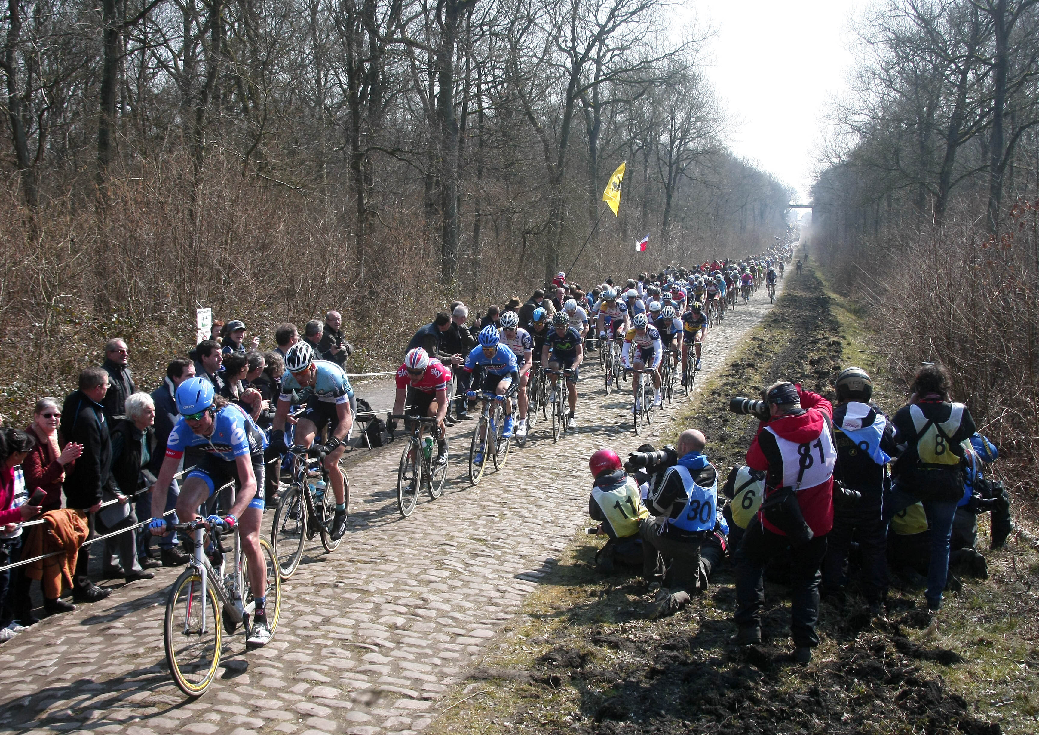FILE - Riders steer their bikes on a cobblestone-paved section in Arenberg during the 111th edition of the Paris-Roubaix cycling classic, a 254 kilometer (158 mile) one day race, of which 52.6 kilometers (32.7 miles) are run on cobblestones, in Roubaix, northern France, Sunday, April 7, 2013. 
