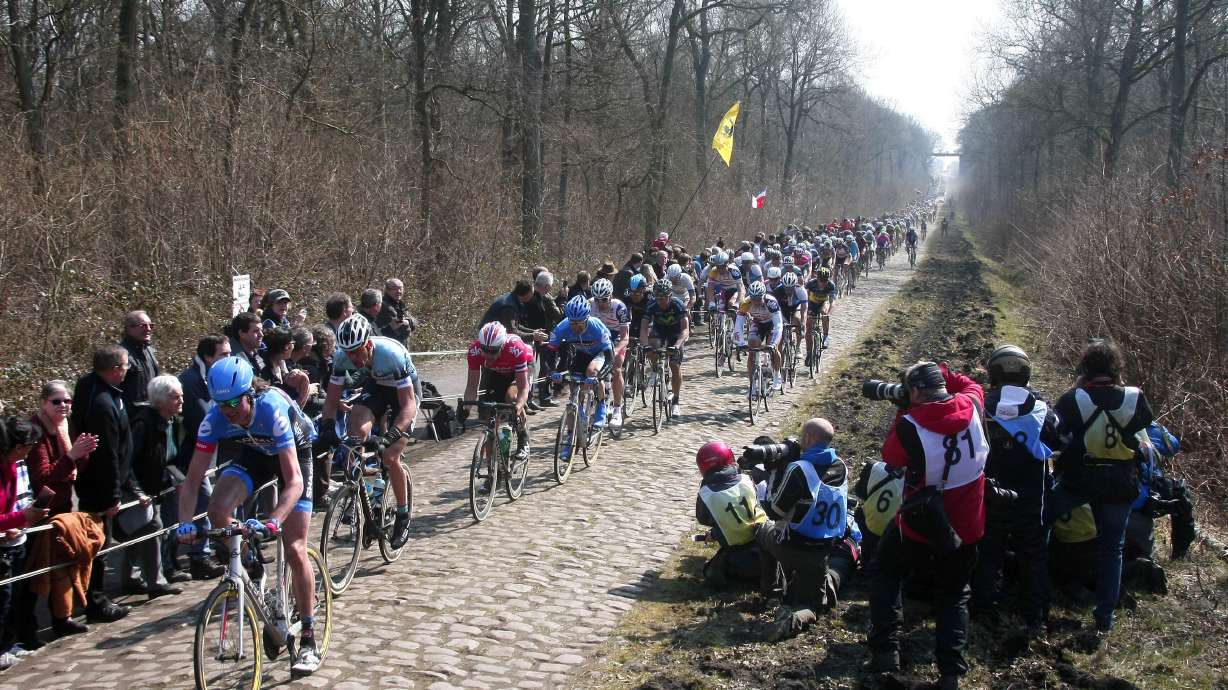 FILE - Riders steer their bikes on a cobblestone-paved section in Arenberg during the 111th edition of the Paris-Roubaix cycling classic, a 254 kilometer (158 mile) one day race, of which 52.6 kilometers (32.7 miles) are run on cobblestones, in Roubaix, northern France, Sunday, April 7, 2013.