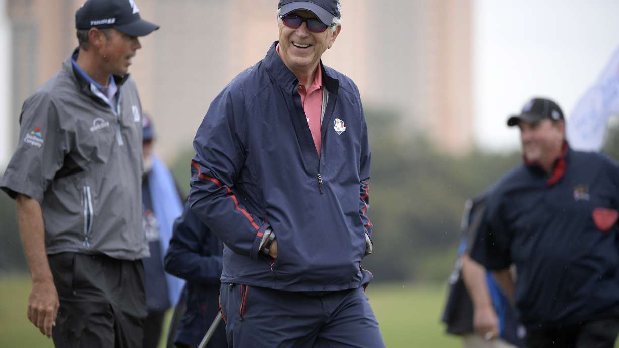 FILE - Matt Kuchar, left, and his father, Peter Kuchar, center, leave the second green after making their putt during the first round of the Father Son Challenge golf tournament Saturday, Dec. 15, 2018, in Orlando, Fla.