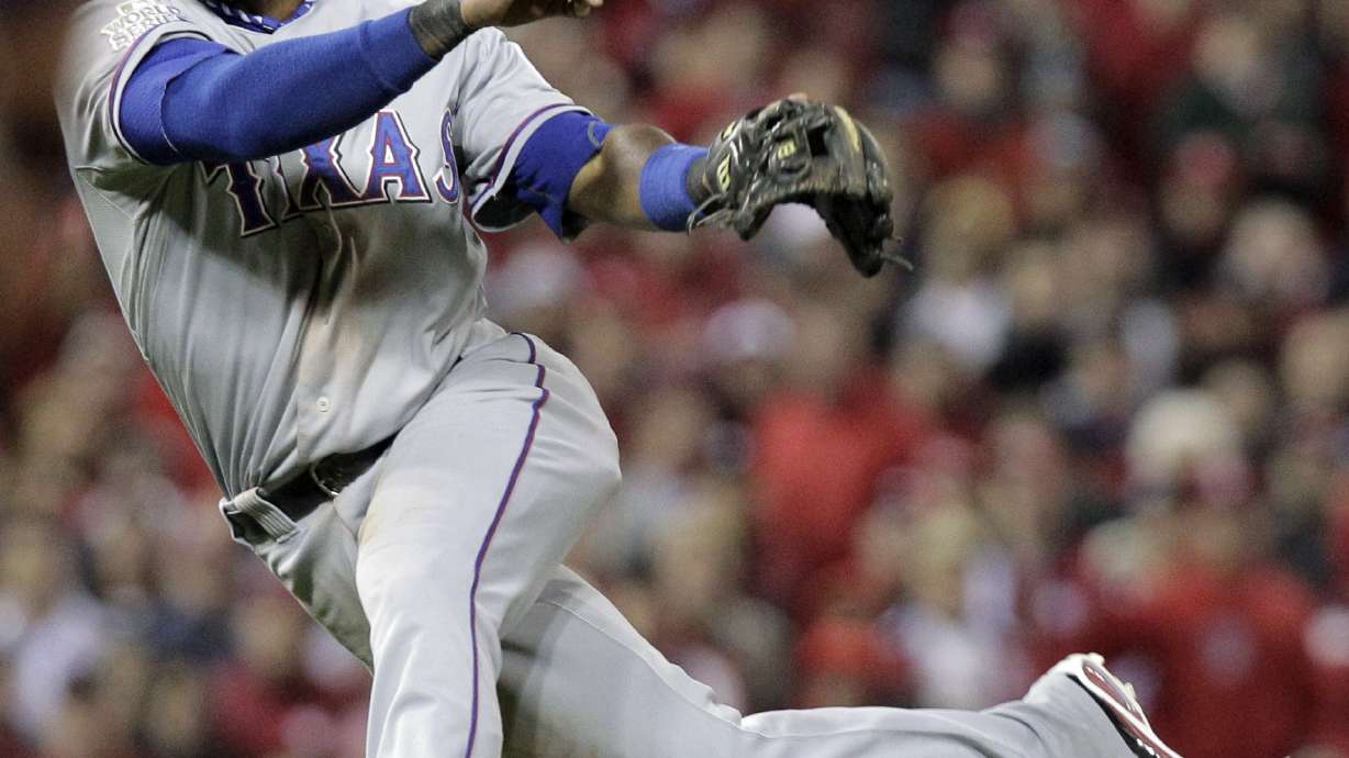 FILE - Texas Rangers' Elvis Andrus makes a play on a ball during the seventh inning of Game 7 of baseball's World Series against the St. Louis Cardinals, Oct. 28, 2011, in St. Louis.