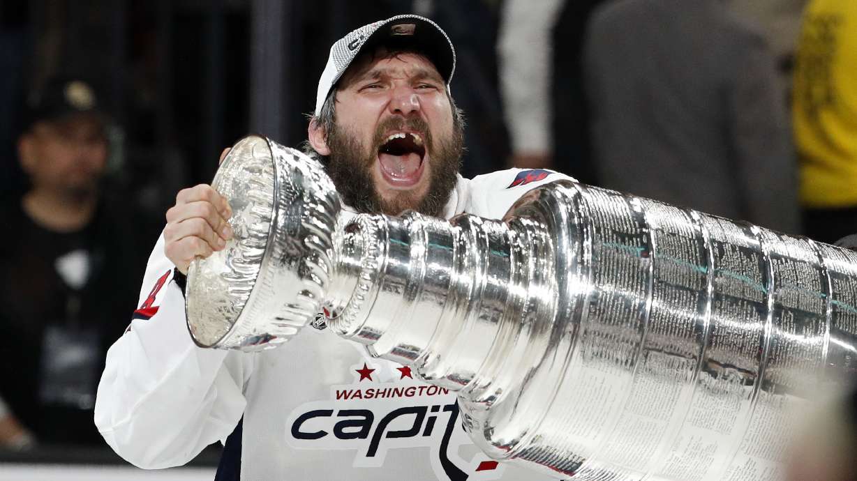 FILE - Washington Capitals left wing Alex Ovechkin, of Russia, hoists the Stanley Cup after the Capitals defeated the Golden Knights in Game 5 of the NHL hockey Stanley Cup Finals Thursday, June 7, 2018, in Las Vegas. (AP Photo/John Locher, File(