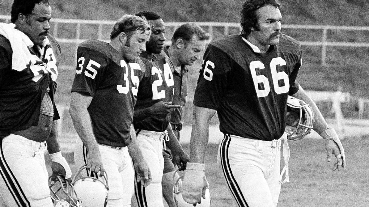 FILE - St. Louis Cardinals' Conrad Dobler (66) leads the march off the field at the end of practice at the NFL football team's training camp at St. Charles, Mo., Aug. 5, 1977..