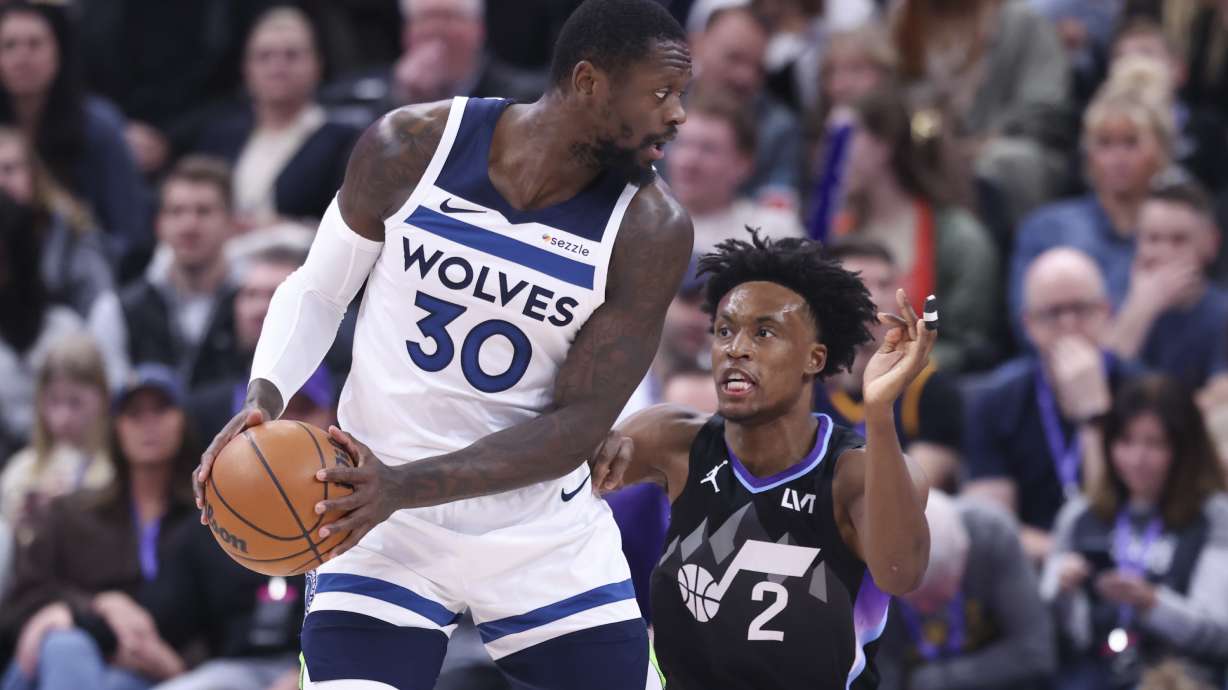 Minnesota Timberwolves forward Julius Randle (30) posts up against Utah Jazz guard Collin Sexton (2) during the first quarter of an NBA basketball game, Thursday, Jan. 30, 2025, in Salt Lake City.