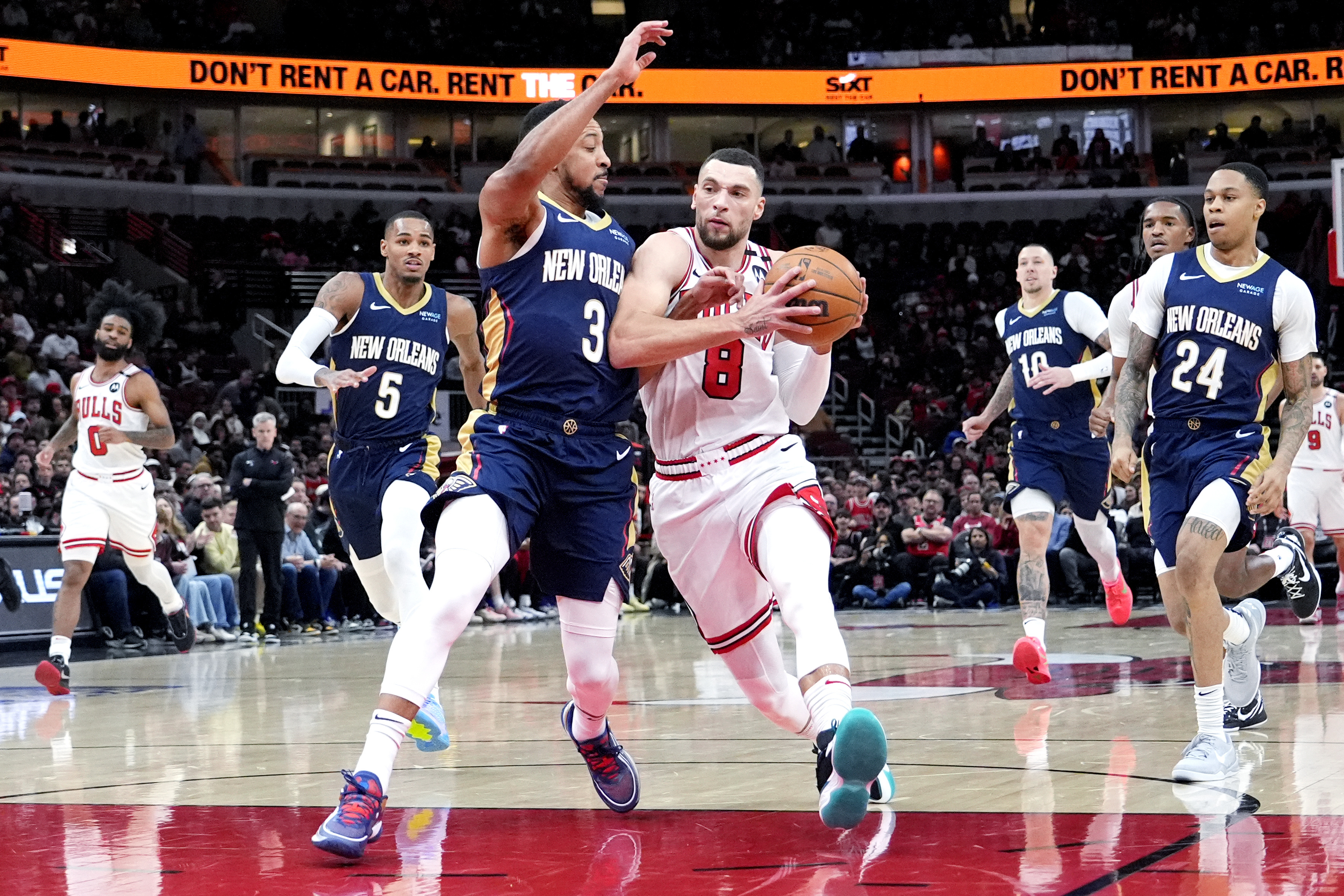 Chicago Bulls guard Zach LaVine (8) drives to the basket as New Orleans Pelicans guard CJ McCollum (3) guards during the first half of an NBA basketball game in Chicago, Tuesday, Jan. 14, 2025. 