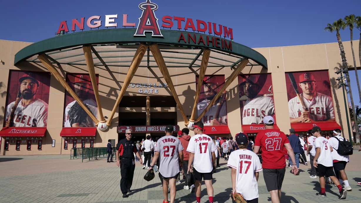 FILE - Fans enter Angels Stadium before the start of a baseball game in Anaheim, Calif., April 7, 2022.