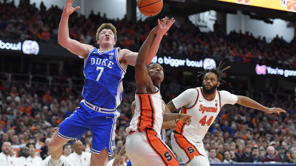 Duke guard/forward Kon Knueppel (7) reaches for a rebound against Syracuse forward Jyare Davis (13) during the first half of an NCAA college basketball game in Syracuse, N.Y., Wednesday, Feb. 5, 2025.