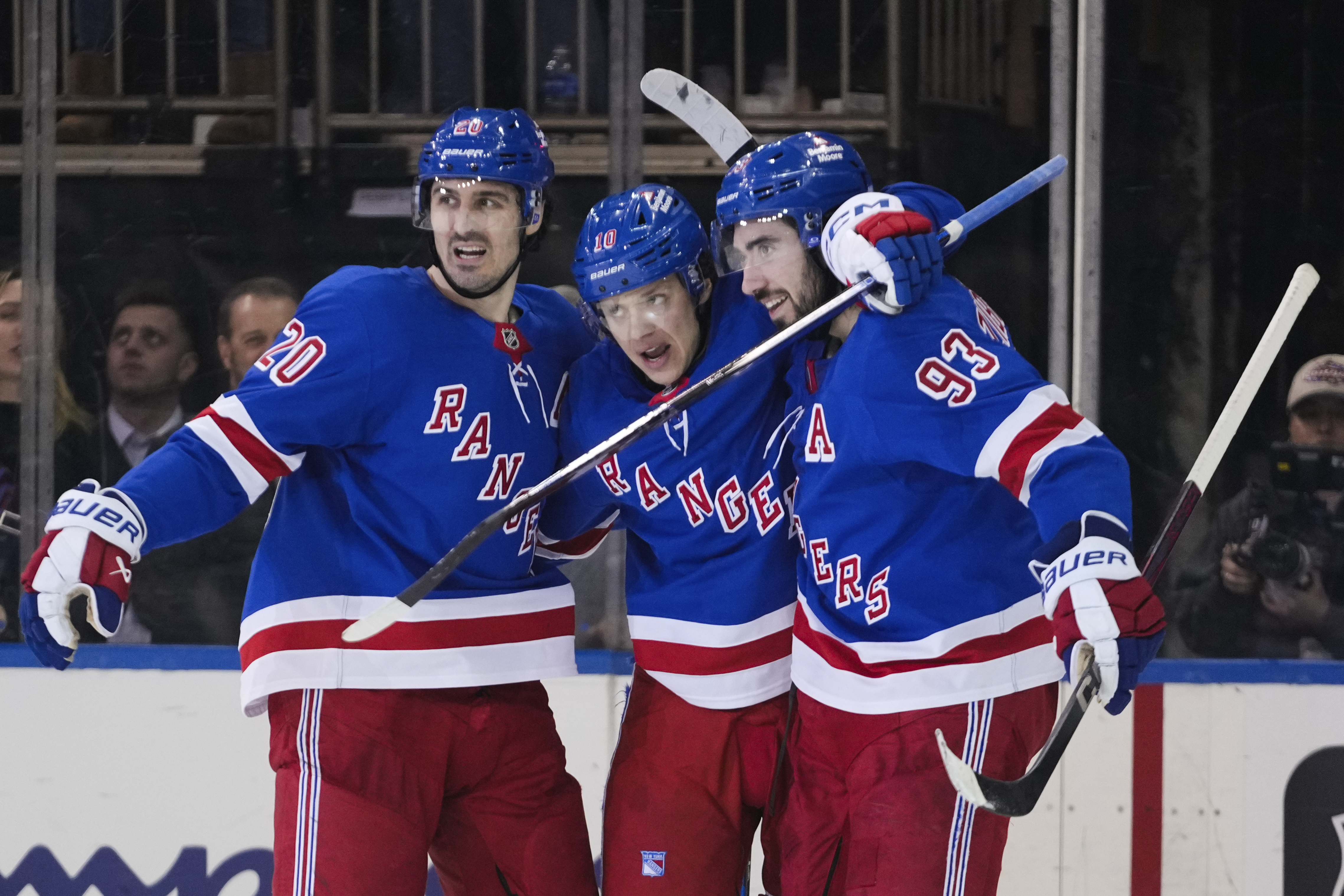 New York Rangers left wing Artemi Panarin (10) celebrates with teammates Chris Kreider (20) and Mika Zibanejad (93) after scoring a goal during the third period of an NHL hockey game against the Vegas Golden Knights Sunday, Feb. 2, 2025, in New York.