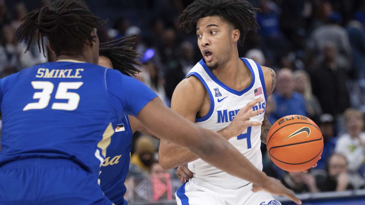 Tulsa forward Ian Smikle (35) and Tulsa guard Jesaiah McWright, center, defend Memphis guard PJ Haggerty (4) during the first half of an NCAA college basketball game Wednesday, Feb. 5, 2025, in Memphis, Tenn.