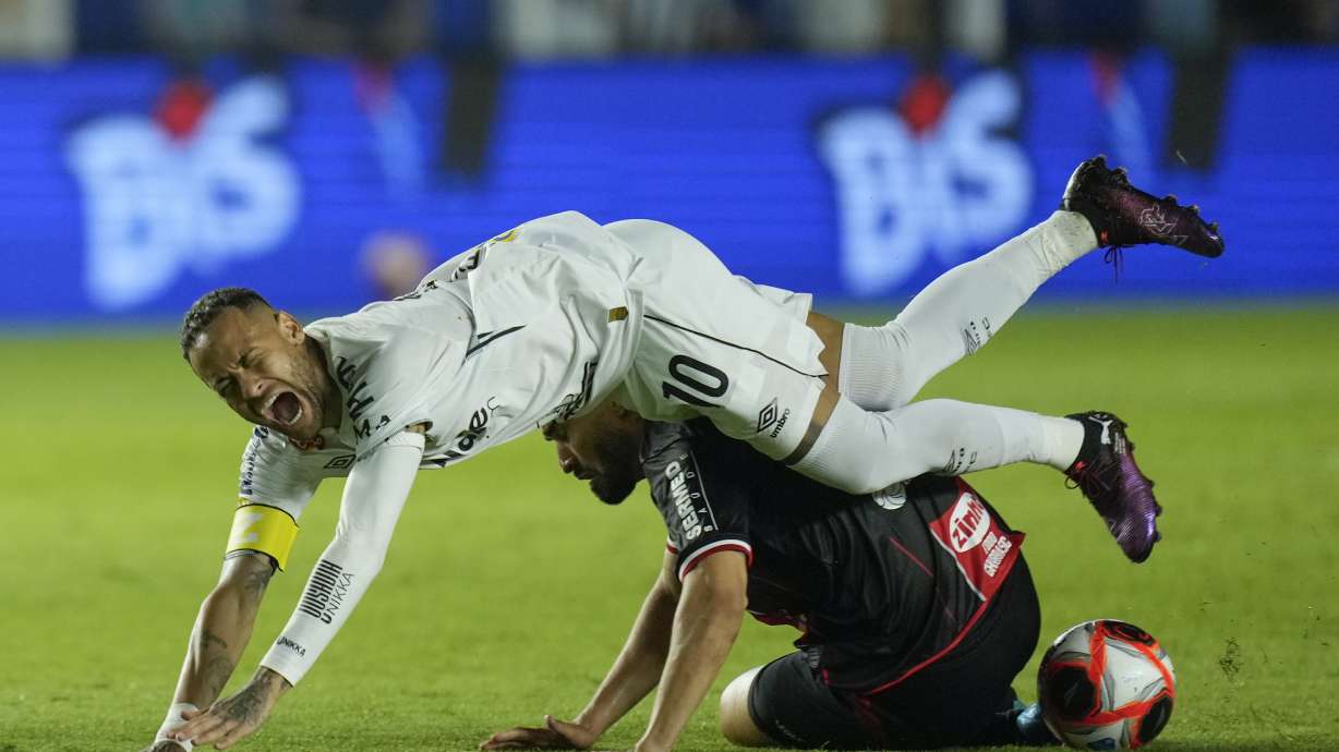 Brazil's Neymar is fouled by Botafogo-SP's Alisson Cassiano during his debut match for Santos FC, in a Sao Paulo league soccer match, in Santos, Brazil, Wednesday, Feb. 5, 2025.