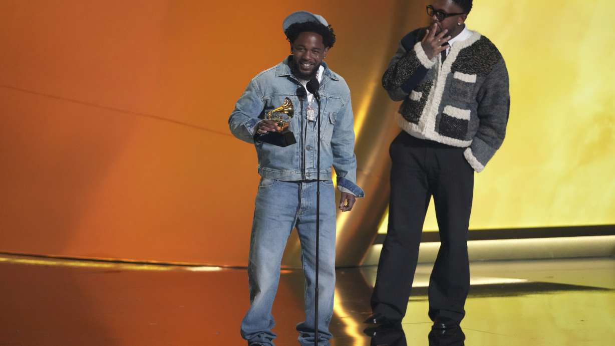 Kendrick Lamar, left, accepts the record of the year award for "Not Like Us during the 67th annual Grammy Awards on Sunday, Feb. 2, 2025, in Los Angeles. Mustard looks on from right.