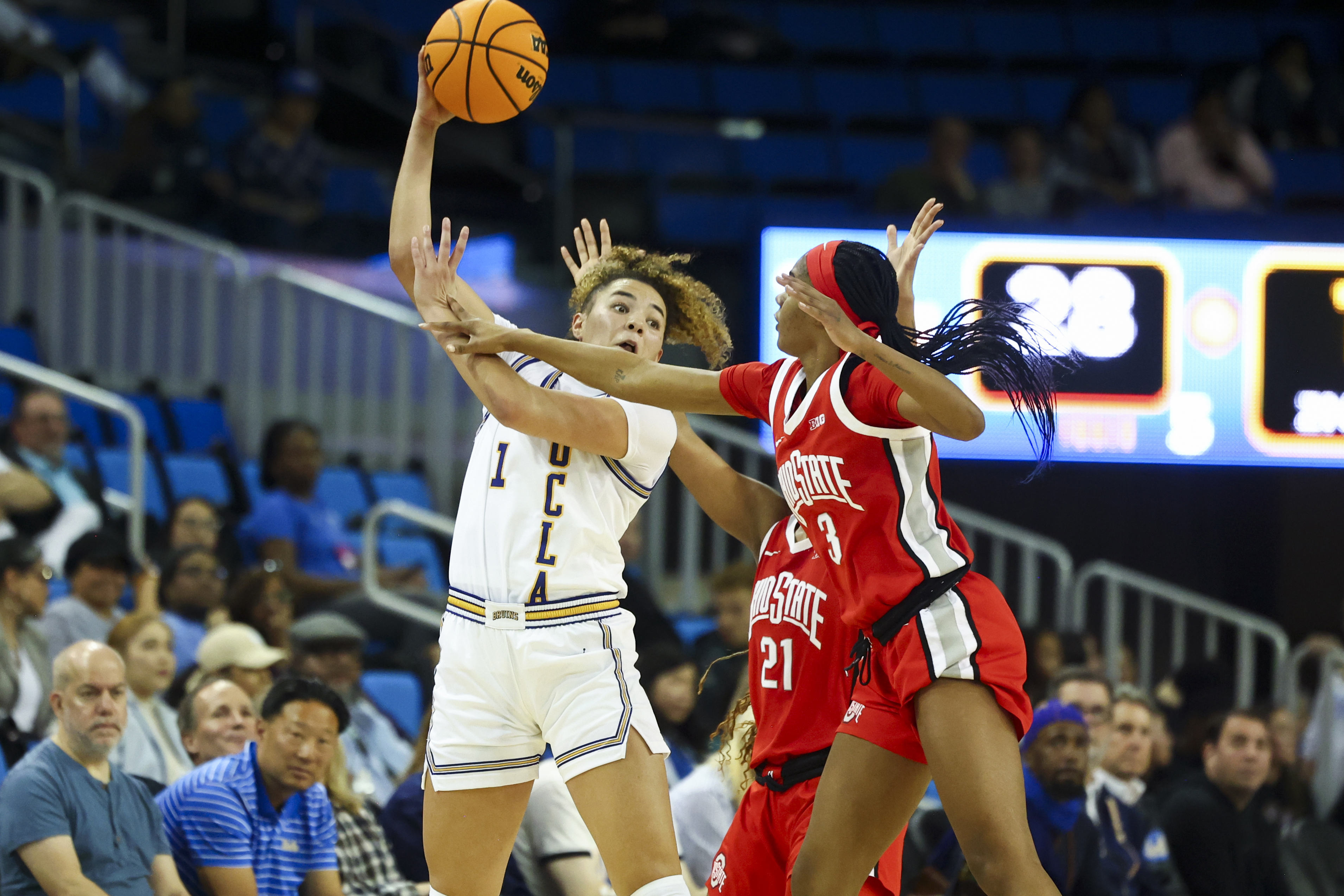 UCLA guard Kiki Rice (1) looks to pass the ball against Ohio State guard Kennedy Cambridge (3) during the first half of an NCAA college basketball game Wednesday, Feb. 5, 2025, in Los Angeles.