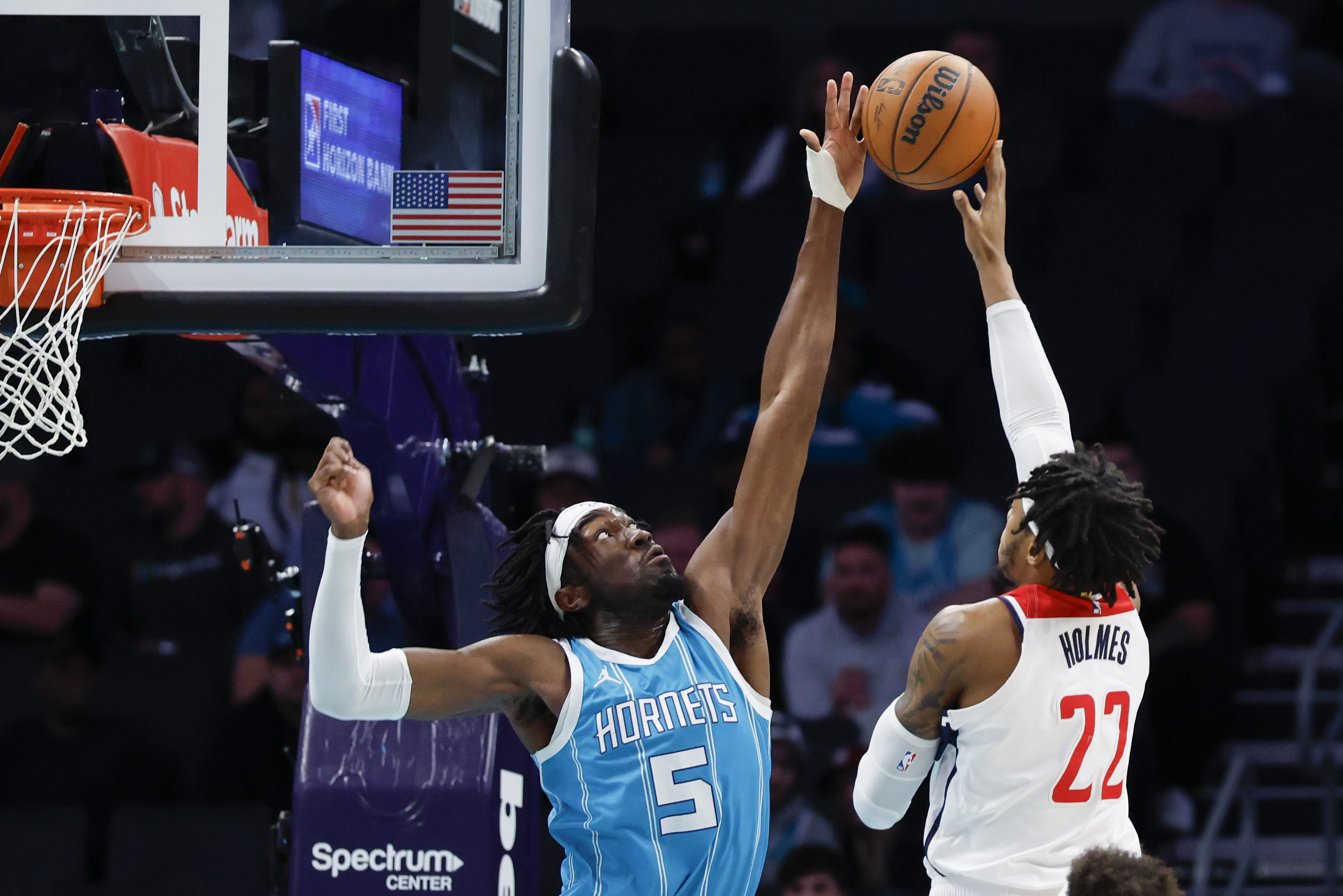 Charlotte Hornets center Mark Williams (5) blocks a shot by Washington Wizards forward Richaun Holmes (22) during the first half of an NBA basketball game in Charlotte, N.C., Monday, Feb. 3, 2025.