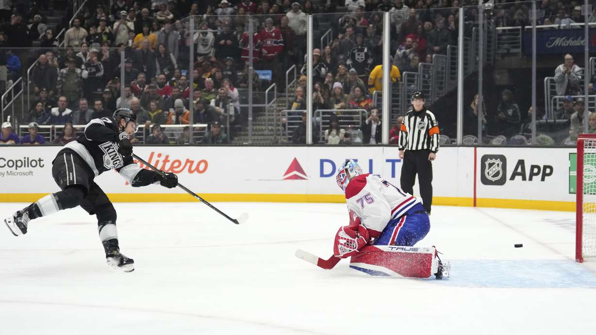 Los Angeles Kings left wing Warren Foegele, left, scores on Montreal Canadiens goaltender Jakub Dobes during a penalty shot in the second period of an NHL hockey game, Wednesday, Feb. 5, 2025, in Los Angeles.