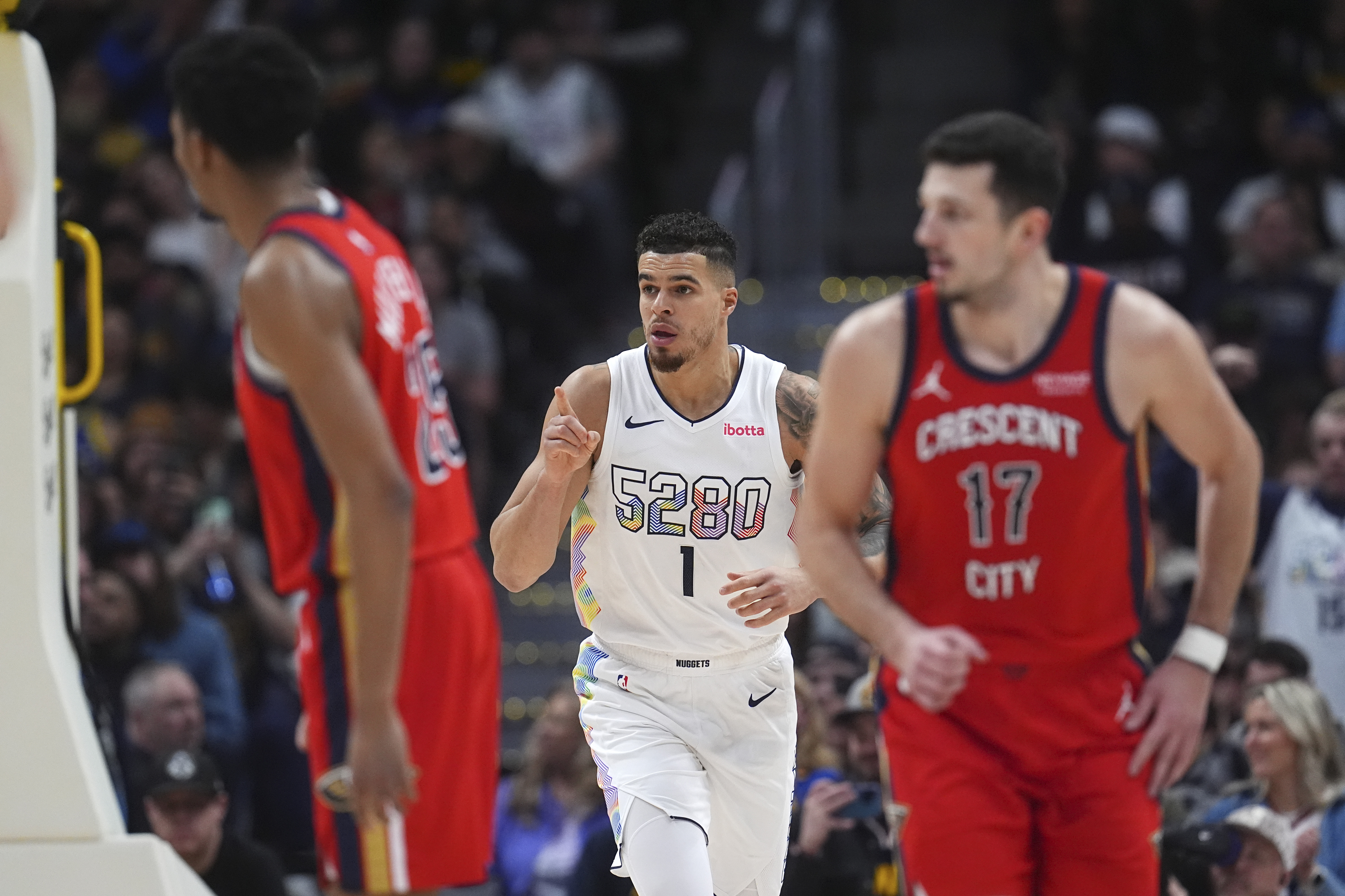 Denver Nuggets forward Michael Porter Jr., center, gestures after scoring a basket as New Orleans Pelicans guard Trey Murphy III, front left, and center Karlo Matkovic drops back on offense in the second half of an NBA basketball game Wednesday, Feb. 5, 2025, in Denver.