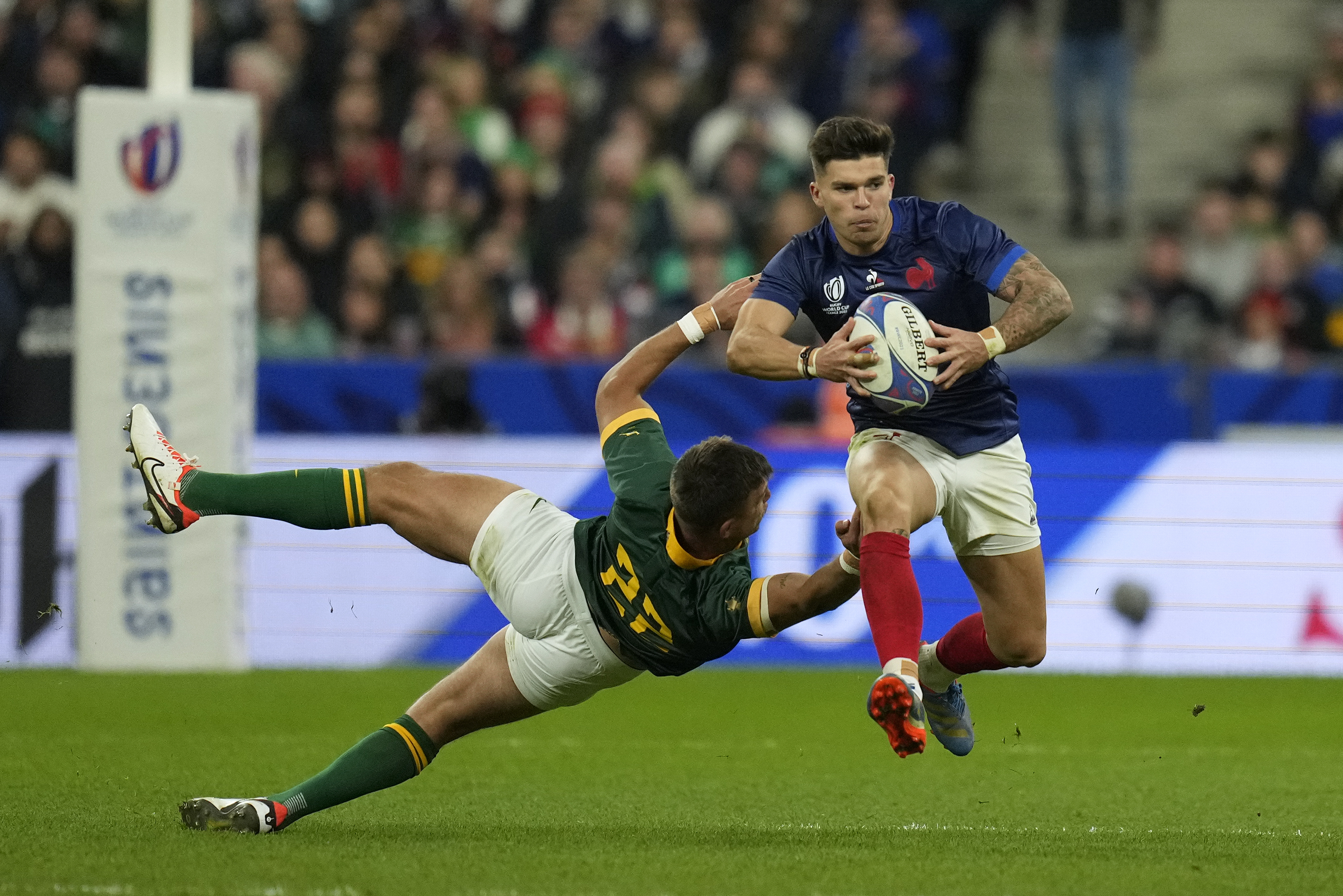 FILE - France's Matthieu Jalibert, right, gets past South Africa's Handre Pollard during the Rugby World Cup quarterfinal match between France and South Africa at the Stade de France in Saint-Denis, near Paris, Oct. 15, 2023.