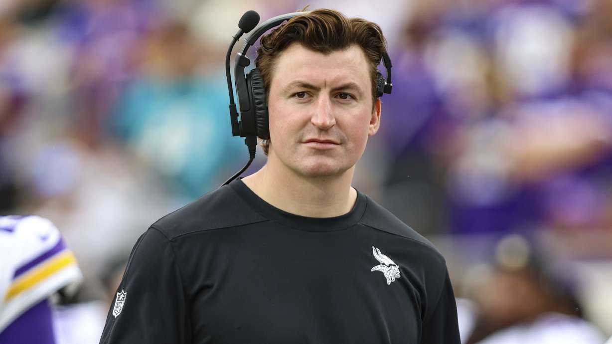 FILE - Minnesota Vikings assistant offensive coordinator/assistant quarterbacks coach Grant Udinski walks the sideline before an NFL football game against the Jacksonville Jaguars, Nov. 10, 2024, in Jacksonville, Fla.