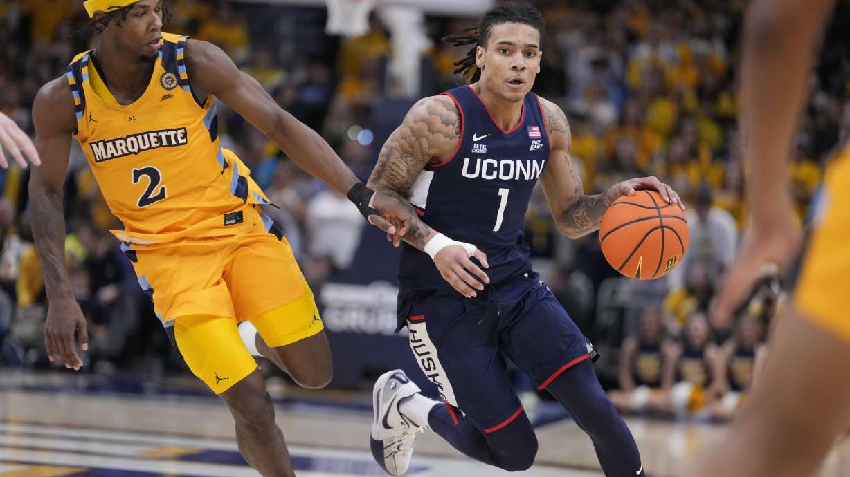 UConn's Solo Ball gets past Marquette's Chase Ross during the second half of an NCAA college basketball game Saturday, Feb. 1, 2025, in Milwaukee.