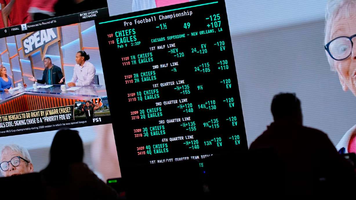Betting odds for the Super Bowl are displayed on monitors at the Circa Resort & Casino sportsbook, Jan. 30 in Las Vegas. Nearly a third say they plan to spend less on the big game this year.