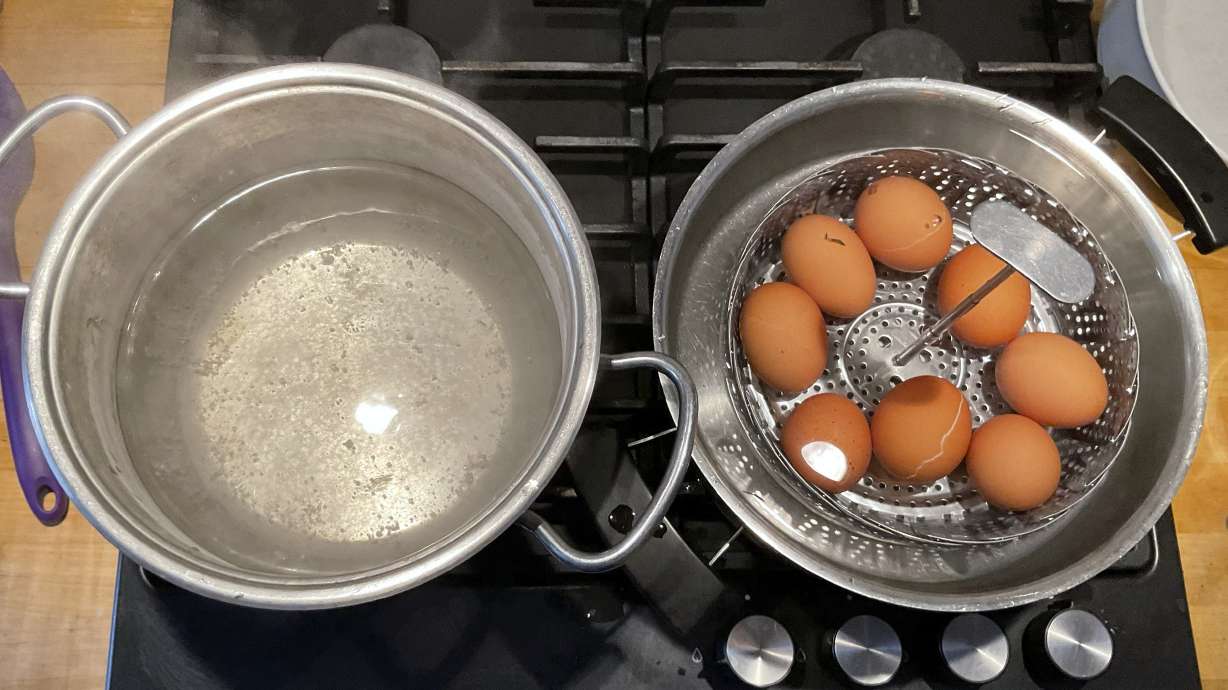 This photo provided by researchers in February 2025 shows two pots, one with boiling water, left, and the other with a basket of eggs in lukewarm water, in a new method of boiling eggs dubbed "periodic cooking."
