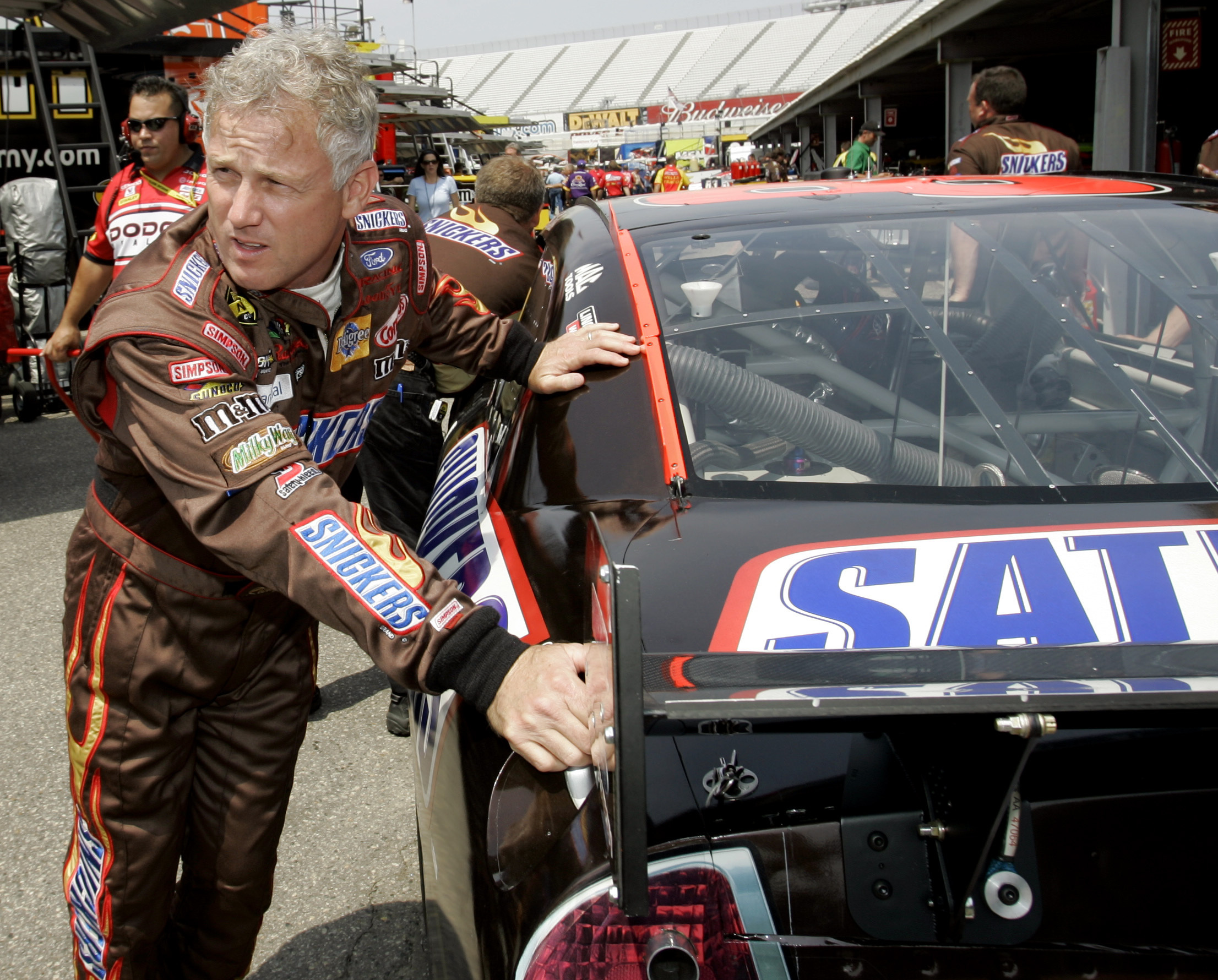 FILE - NASCAR driver Ricky Rudd pushes his car with members of his crew into the garage during practice for the Autism Speaks 400 auto race at Dover Speedway in Dover, Del., Friday, June 1, 2007.
