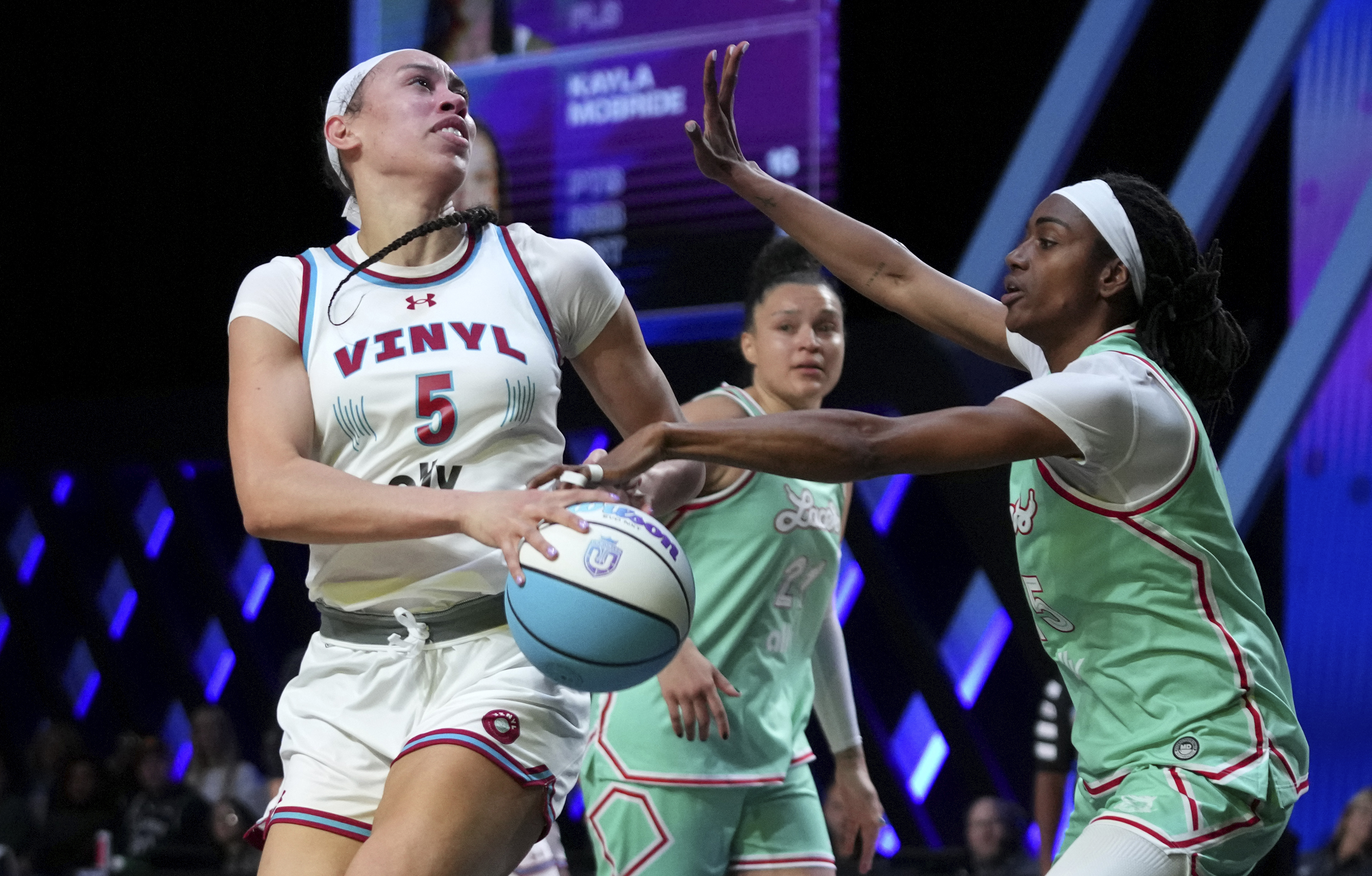 Vinyl forward Dearica Hamby (5) goes to the basket as Laces guard Tiffany Hayes, right, defends during the second half of an Unrivaled 3-on-3 basketball game Friday, Jan. 24, 2025, in Medley, Fla.