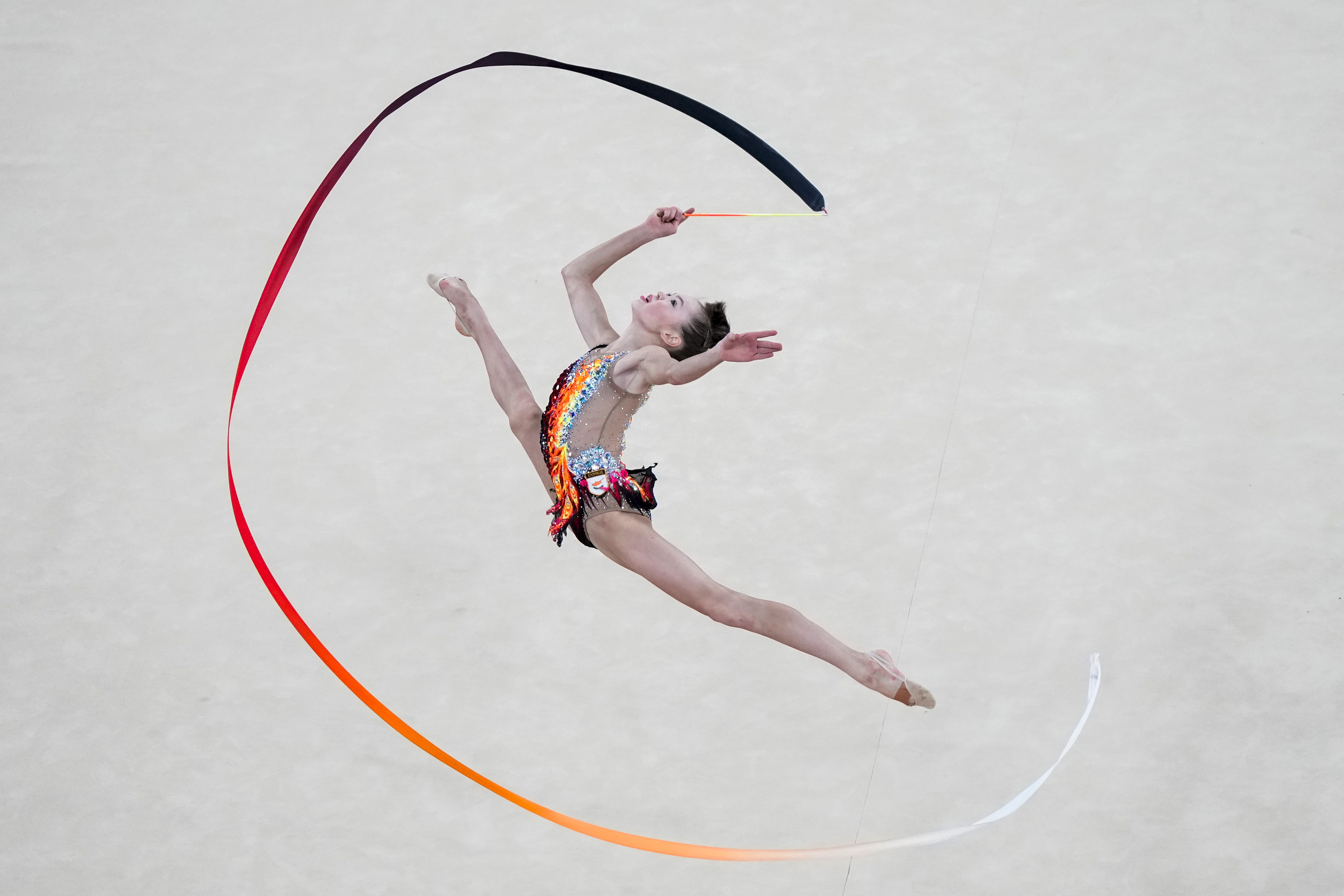 FILE - Vera Tugolukova, of Cyprus, performs her ribbon exercise in the rhythmic gymnastics individuals all-round qualification round at La Chapelle Arena at the 2024 Summer Olympics, Thursday, Aug. 8, 2024, in Paris, France.
