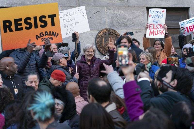 Sen. Elizabeth Warren, D-Mass., accompanied by other members of Congress, speaks to the crowd during a rally against Elon Musk outside the Treasury Department in Washington on Tuesday.