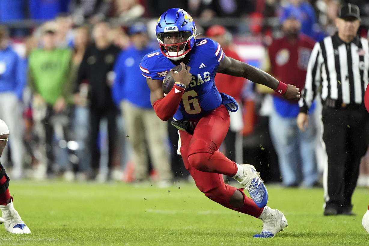 FILE - Kansas quarterback Jalon Daniels runs the ball during the second half of an NCAA college football game against Colorado, Saturday, Nov. 23, 2024, in Kansas City, Mo.