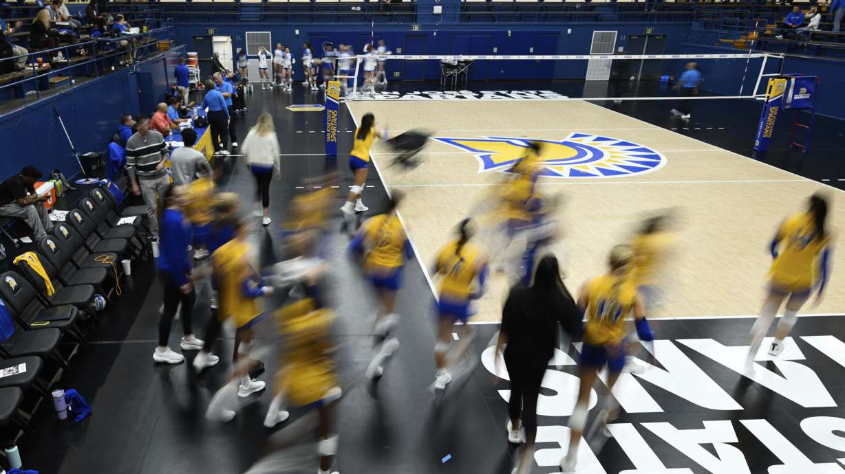 The San Jose State players take the court for warm ups before an NCAA women's college volleyball match against Air Force, Oct. 31, 2024, in San Jose, Calif. The NCAA has changed its participation policy for transgender athletes.