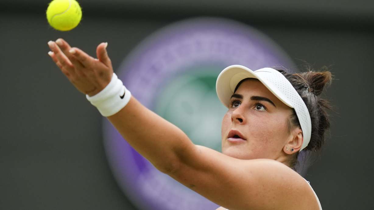 FILE - Bianca Andreescu, of Canada, serves to Jasmine Paolini of Italy during their third round match at the Wimbledon tennis championships in London, July 5, 2024.