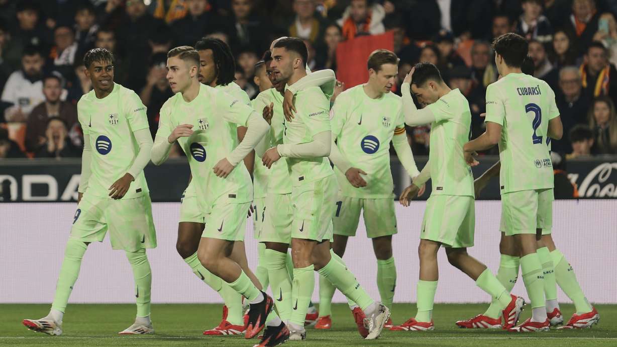 Barcelona's Ferran Torres celebrates with team mates the opening goal during a Spanish Copa del Rey, or King's Cup, quarter-final soccer match between Valencia and Barcelona at the Mestalla Stadium in Valencia, Spain, Thursday Feb. 6, 2025.