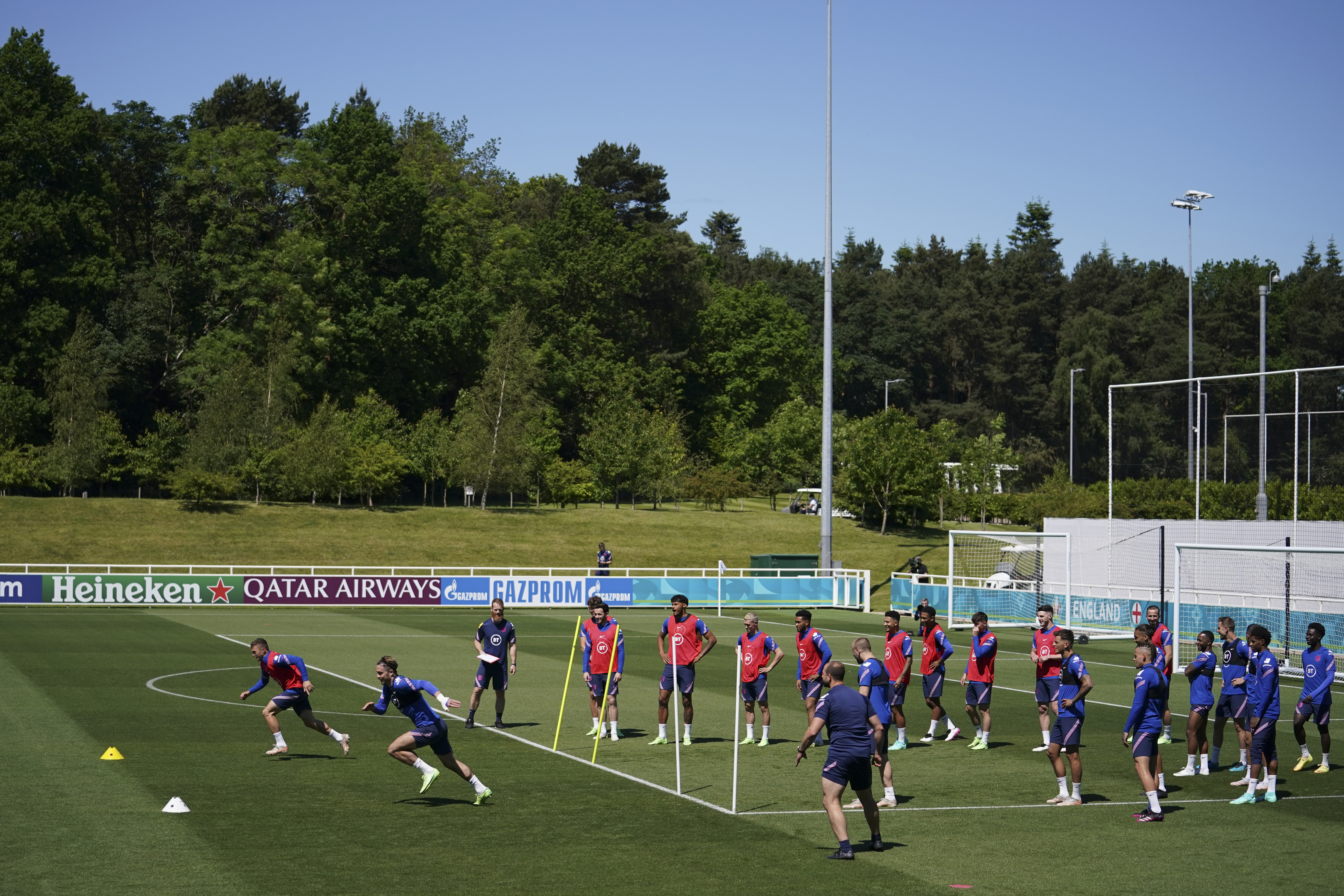 FILE - England players sprint during an open training session at St. George's Park, Burton-upon-Trent, England, June 9, 2021.
