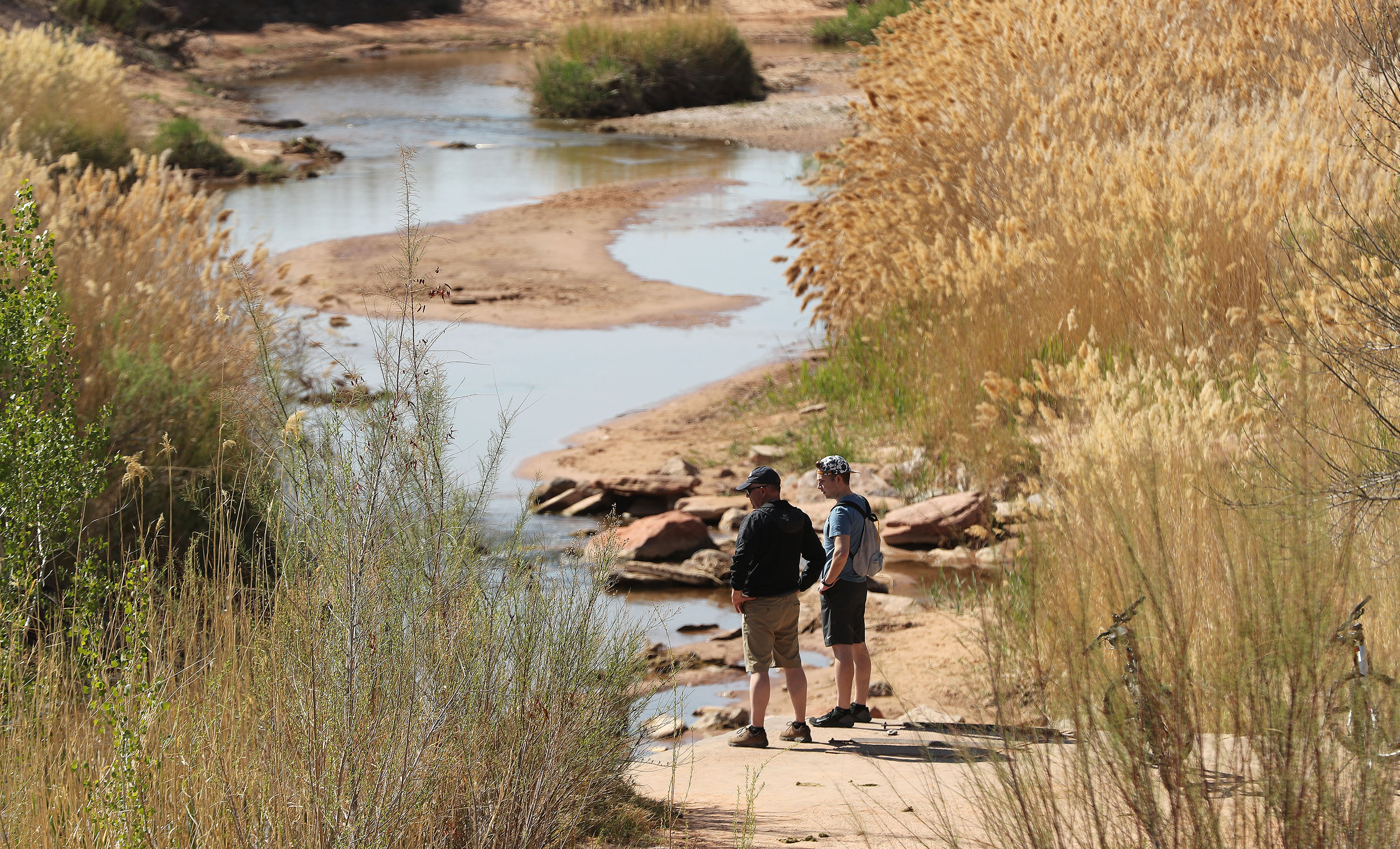 Bikers pause at the Virgin River in St. George on April 10, 2021. Extreme drought returned to the St. George area for the first time since 2022 and the first time anywhere in the state since 2023.