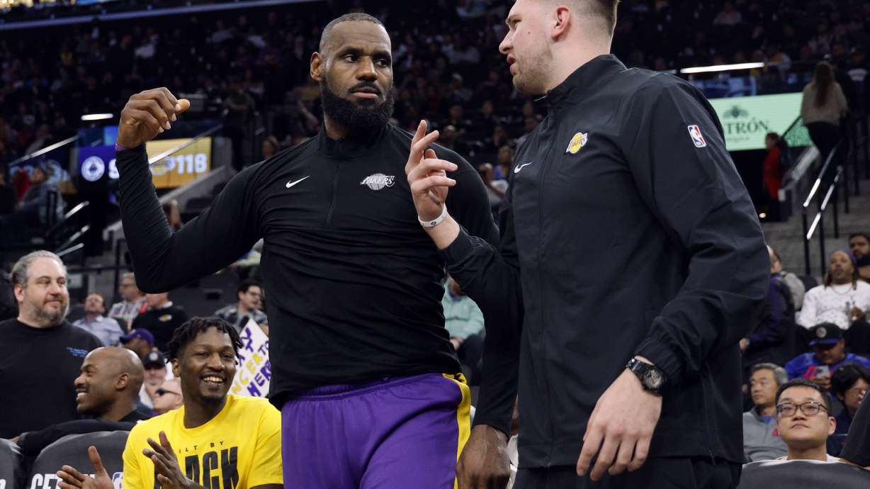 Los Angeles Lakers forward LeBron James, left, and guard Luka Doncic talk during an NBA basketball game against the Los Angeles Clippers, Tuesday, Feb. 4, 2025, in Inglewood, Calif.