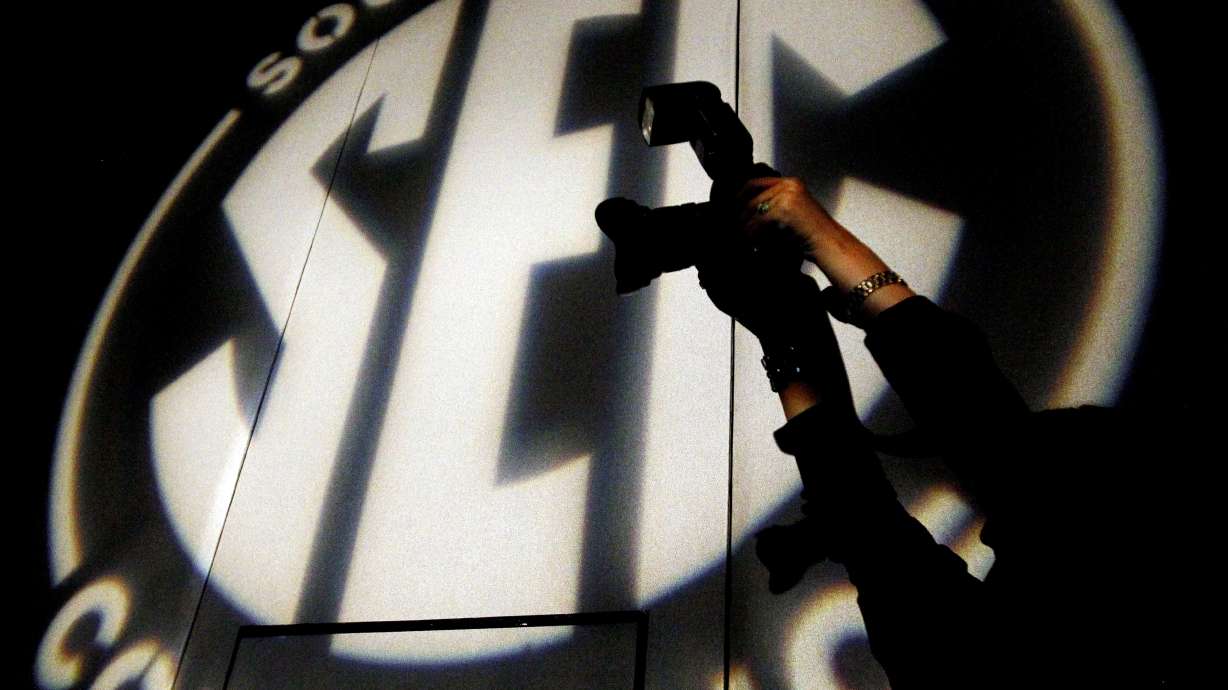 FILE - A photographer takes a photo at the Southeastern Conference NCAA college football media days, in Hoover, Ala., July 15, 2014.