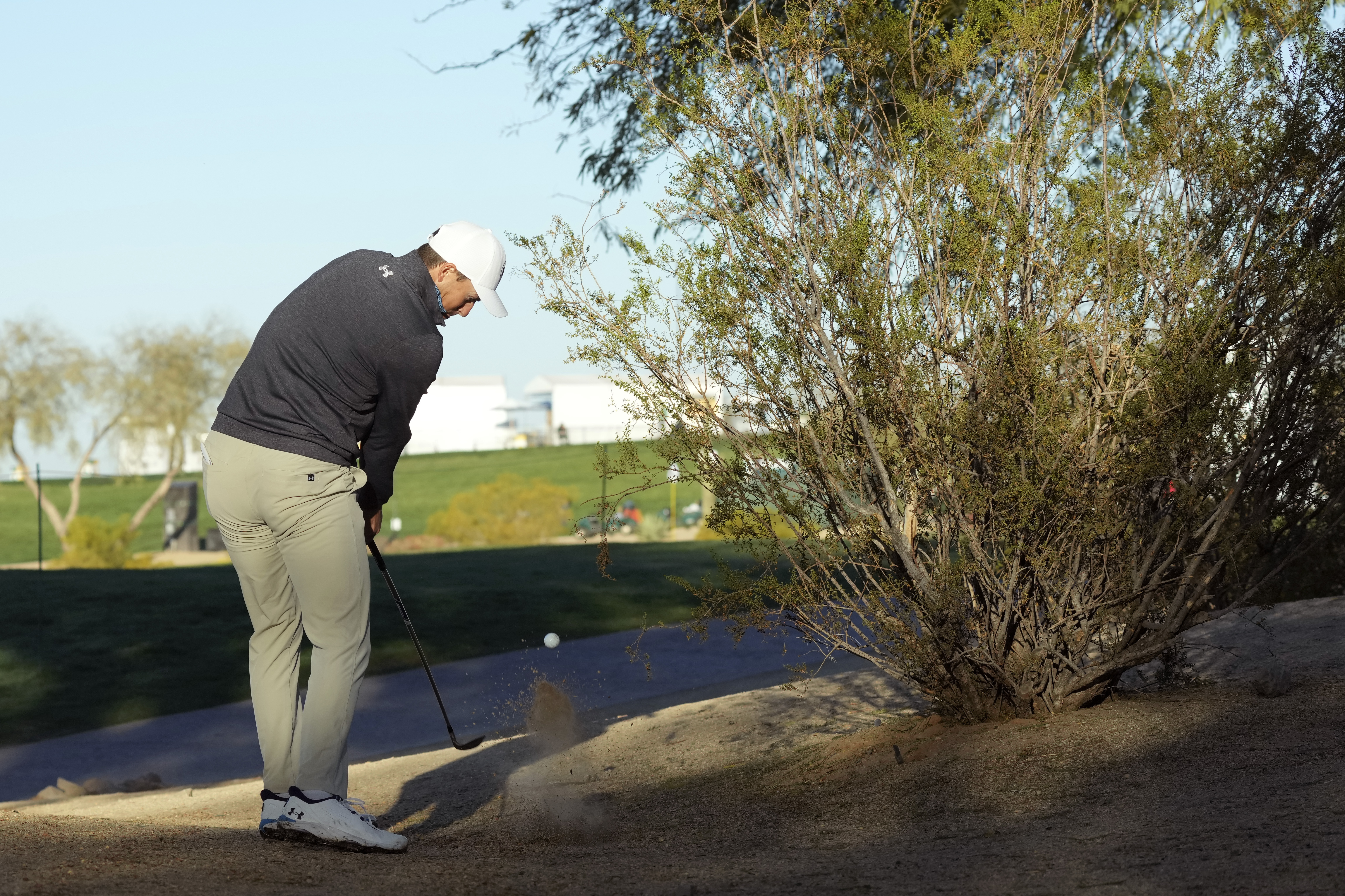 Jordan Spieth hits out of the desert on the 11th hole during the first round of the Waste Management Phoenix Open PGA Tour golf tournament at the TPC Scottsdale Thursday, Feb. 6, 2025, in Scottsdale, Ariz.
