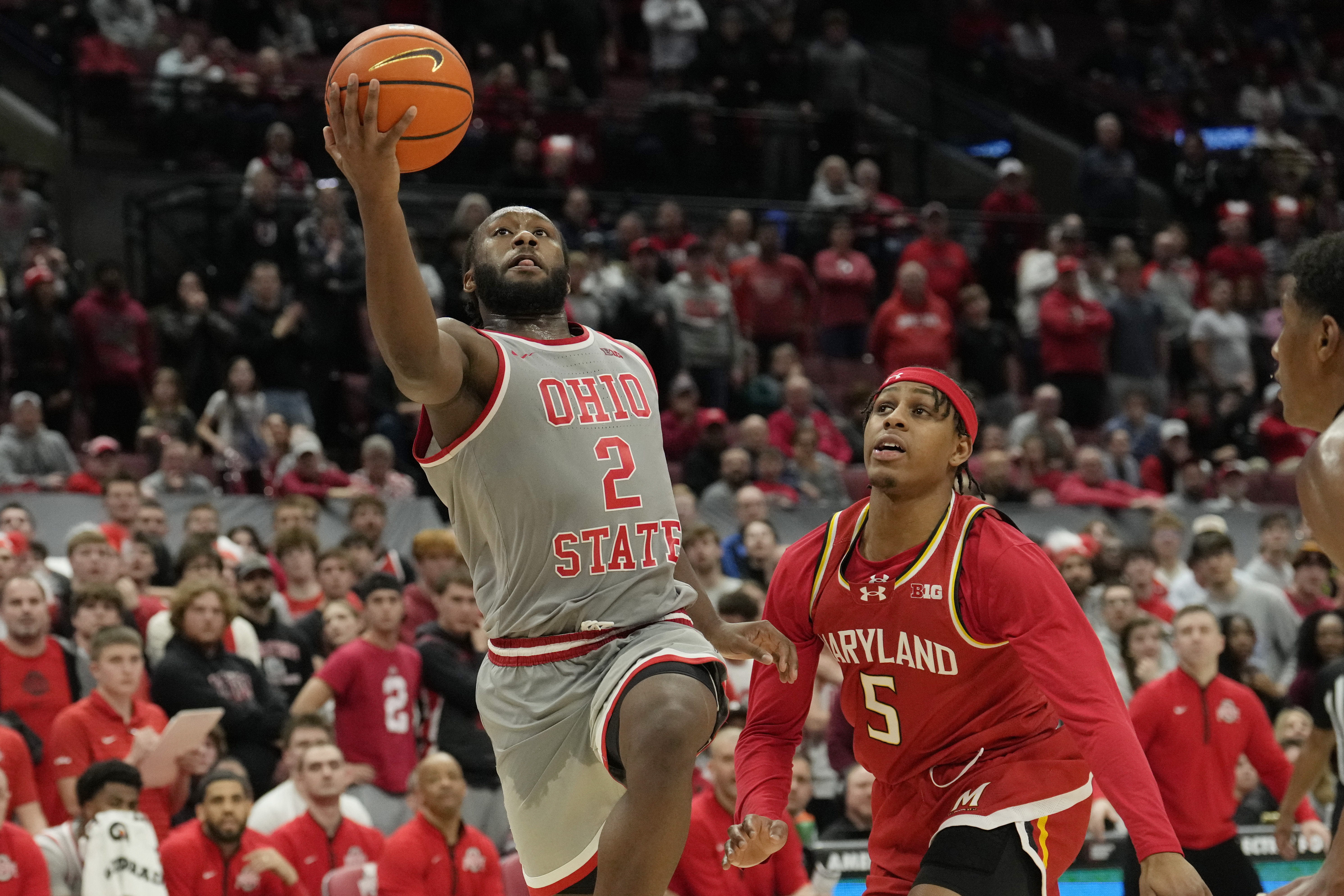 Ohio State guard Bruce Thornton (2) goes to the basket past Maryland guard DeShawn Harris-Smith (5) in the second half of an NCAA college basketball game Thursday, Feb. 6, 2025, in Columbus, Ohio. 