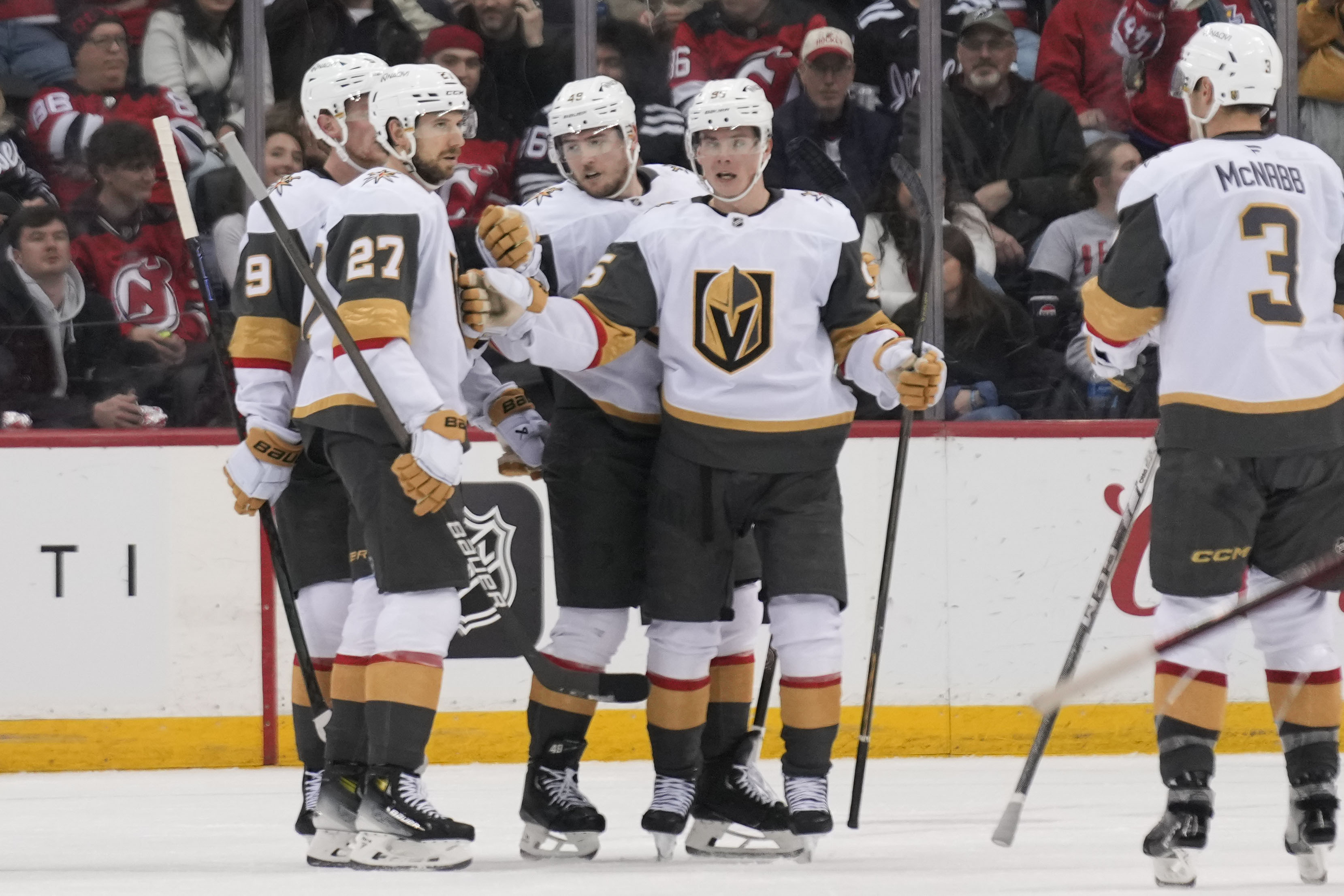 Vegas Golden Knights' Shea Theodore (27), left, celebrates his goal with teammates during the second period of an NHL hockey game against the New Jersey Devils in Newark, N.J., Thursday, Feb. 6, 2025.
