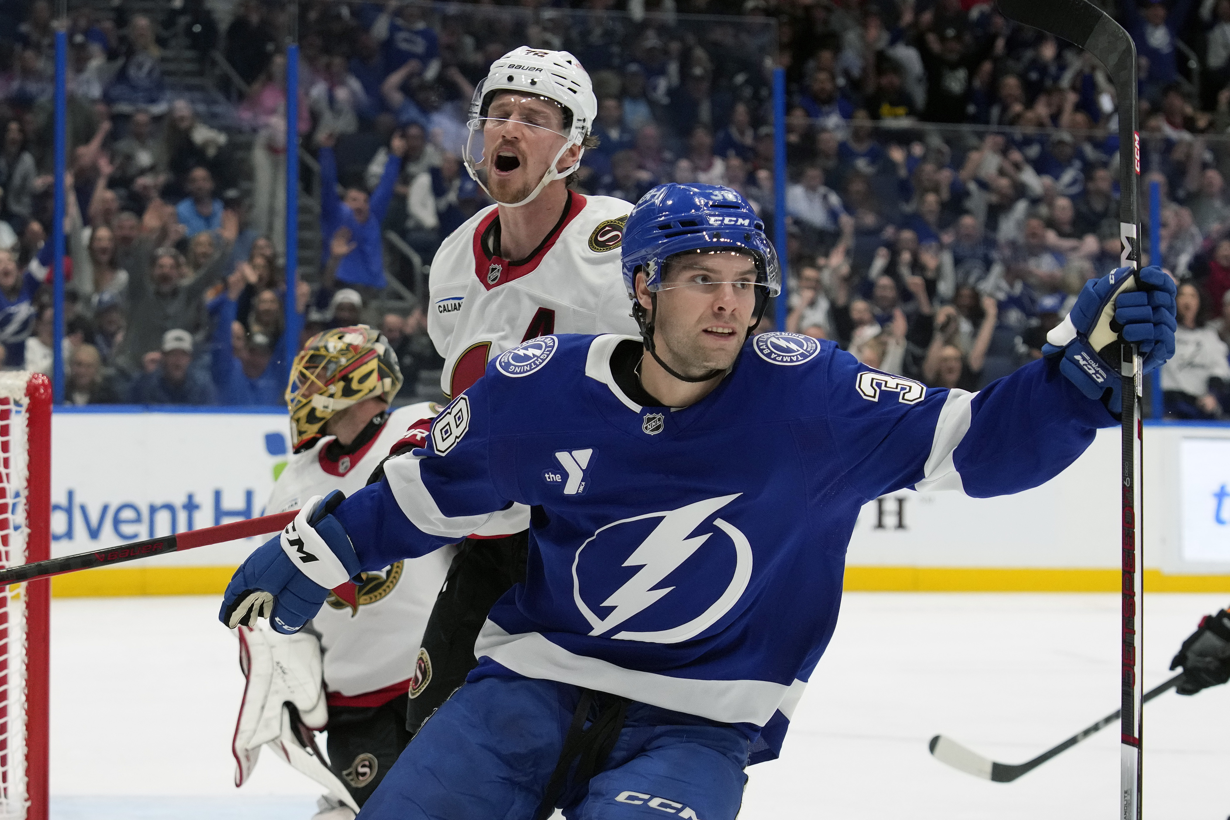 Tampa Bay Lightning left wing Brandon Hagel (38) celebrates in front of Ottawa Senators defenseman Thomas Chabot (72) after scoring past goaltender Anton Forsberg during the second period of an NHL hockey game Thursday, Feb. 6, 2025, in Tampa, Fla.