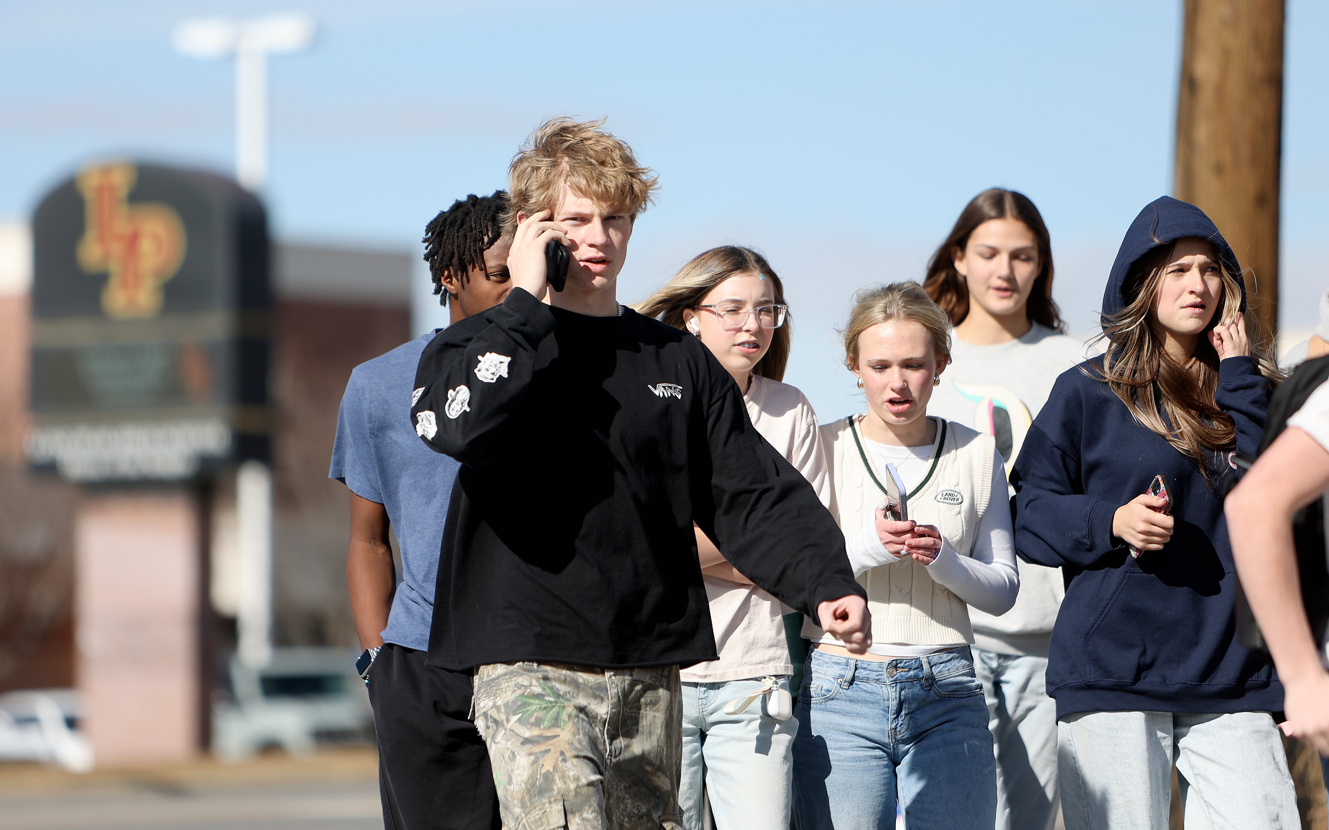 Lone Peak High School student Maxwell Redding talks on the phone during his lunch break at Lone Peak High School on Thursday. Students had mixed response to a proposal to ban cellphones in classrooms.