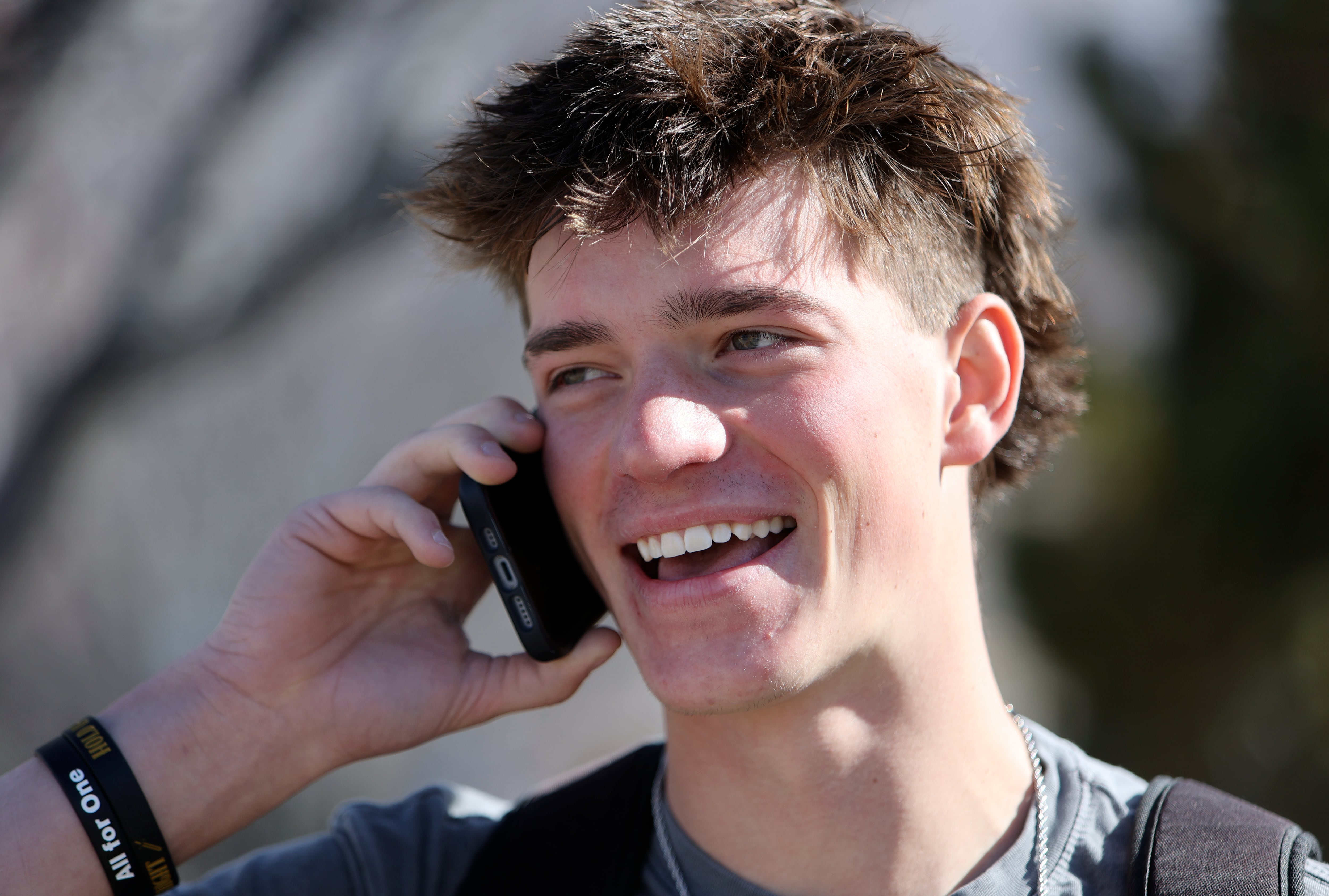 Lone Peak senior Taylor Hurley talks on the phone during his lunch break while walking from Lone Peak High School to a shopping center on the border of Highland and Cedar Hills on Thursday.