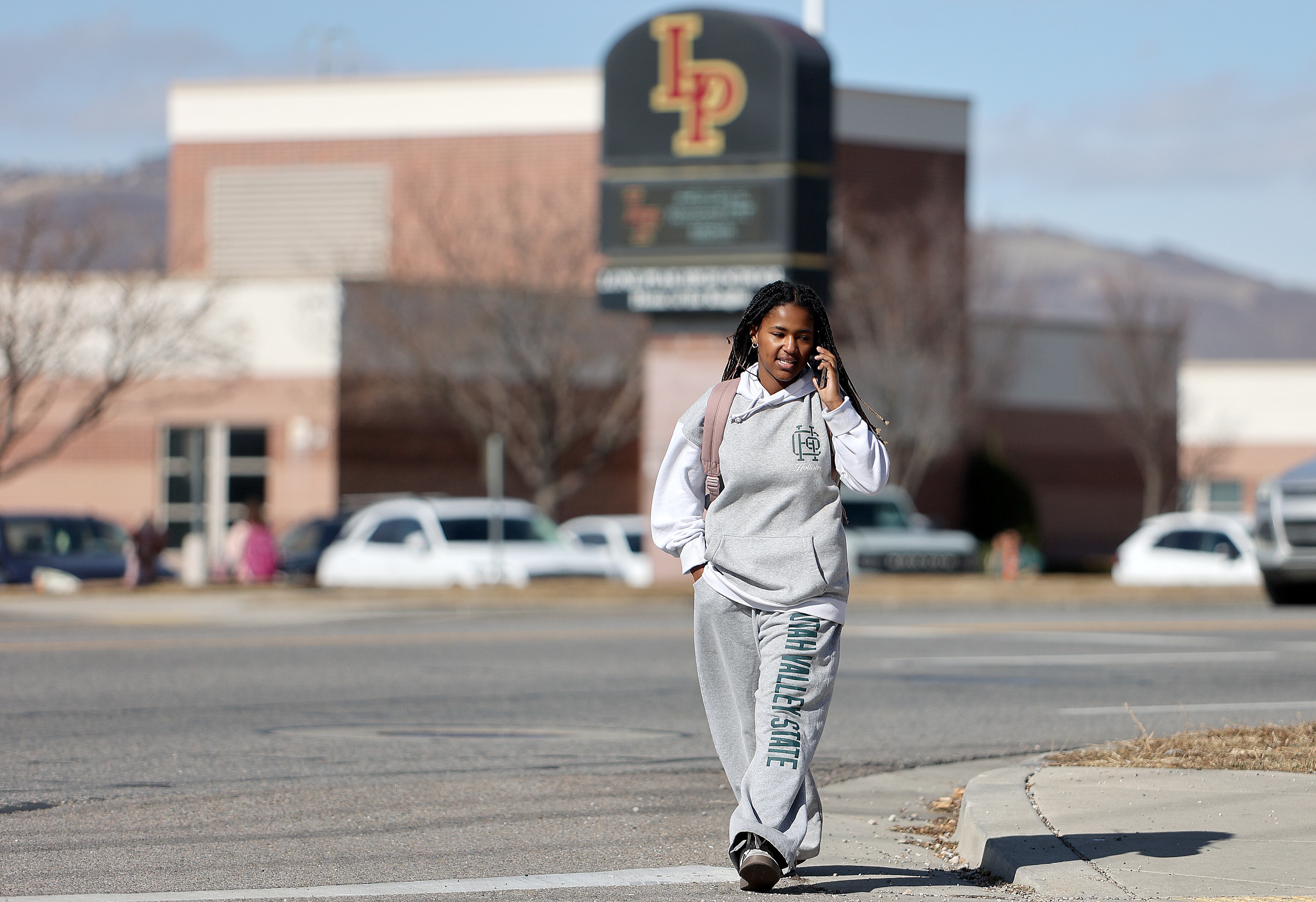 Lone Peak sophomore Anke Larsen talks on the phone during her lunch break while walking from Lone Peak High School to a shopping center on the border of Highland and Cedar Hills on Thursday.