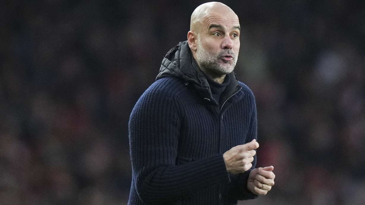 Manchester City's head coach Pep Guardiola gestures during the English Premier League soccer match between Arsenal and Manchester City at the Emirates stadium in London, Sunday, Feb. 2, 2025.