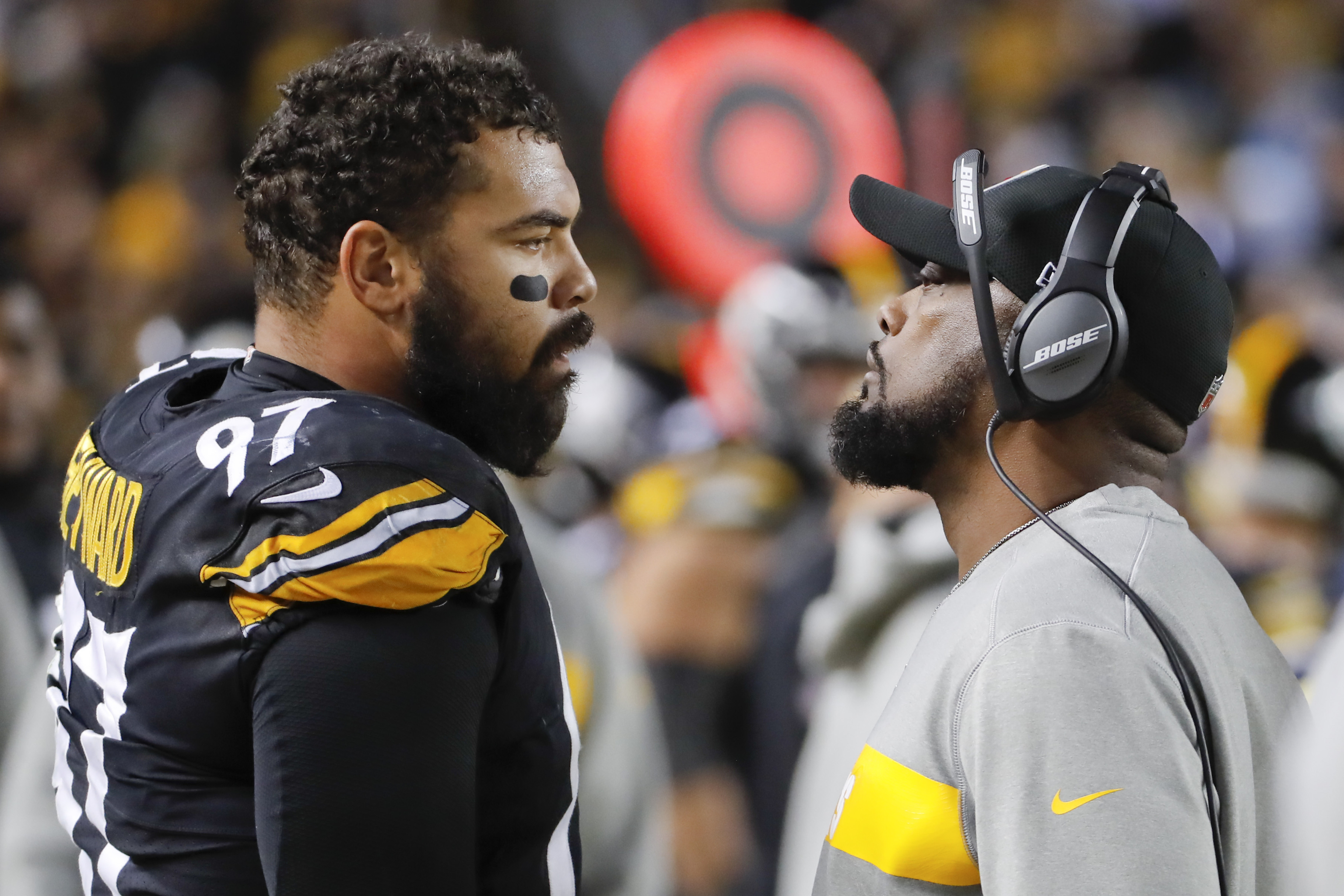 FILE - Pittsburgh Steelers head coach Mike Tomlin, right, talks with defensive end Cameron Heyward (97) in the second half of an NFL football game against the Los Angeles Chargers, Dec. 2, 2018, in Pittsburgh.