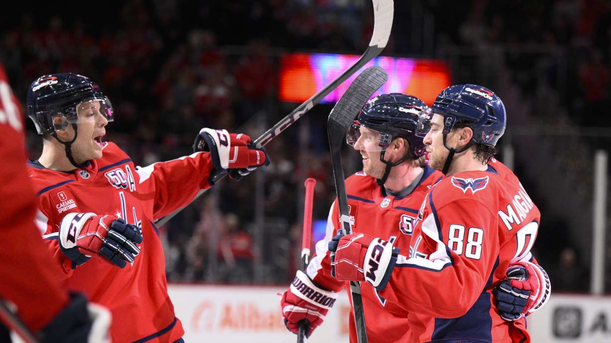 Washington Capitals left wing Andrew Mangiapane (88) celebrates his goal with defensemen John Carlson, right, and Rasmus Sandin, second from left, during the first period of an NHL hockey game against the Florida Panthers, Tuesday, Feb. 4, 2025, in Washington.