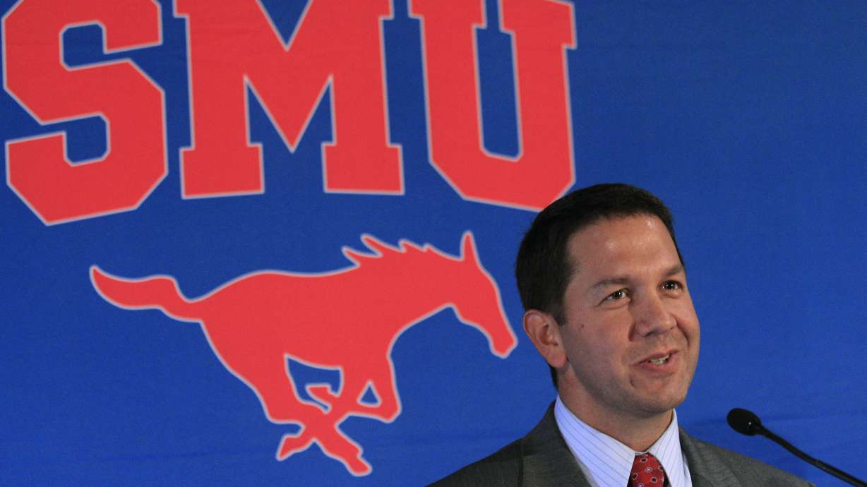 FILE - New SMU athletic director Rick Hart smiles as he talks during his introductory news conference, Monday, July 16, 2012, in Dallas.
