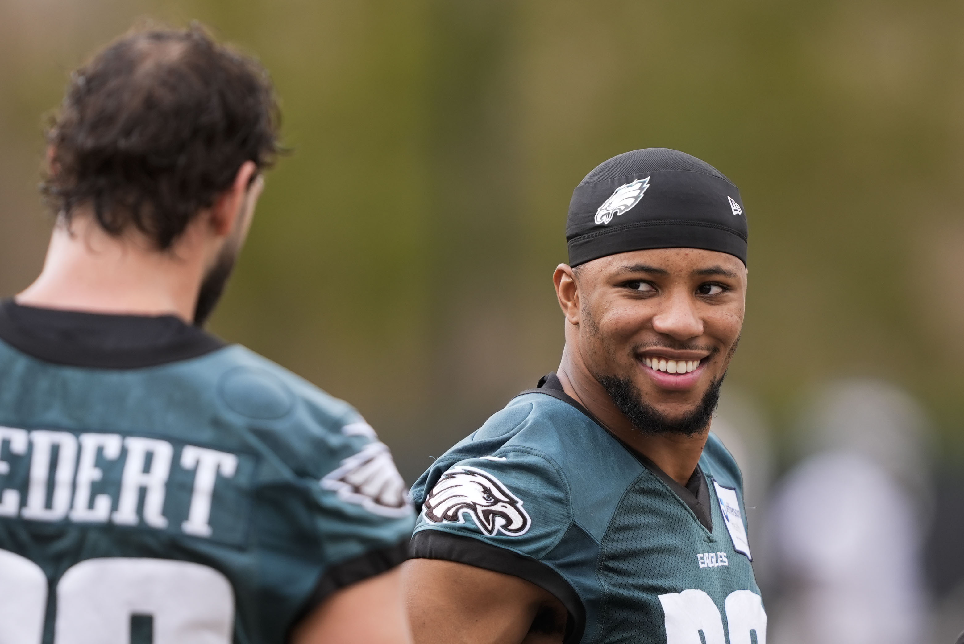 Philadelphia Eagles running back Saquon Barkley talks with tight end Dallas Goedert during an NFL football practice Thursday, Feb. 6, 2025, in New Orleans, ahead of Super Bowl 59 against the Kansas City Chiefs.