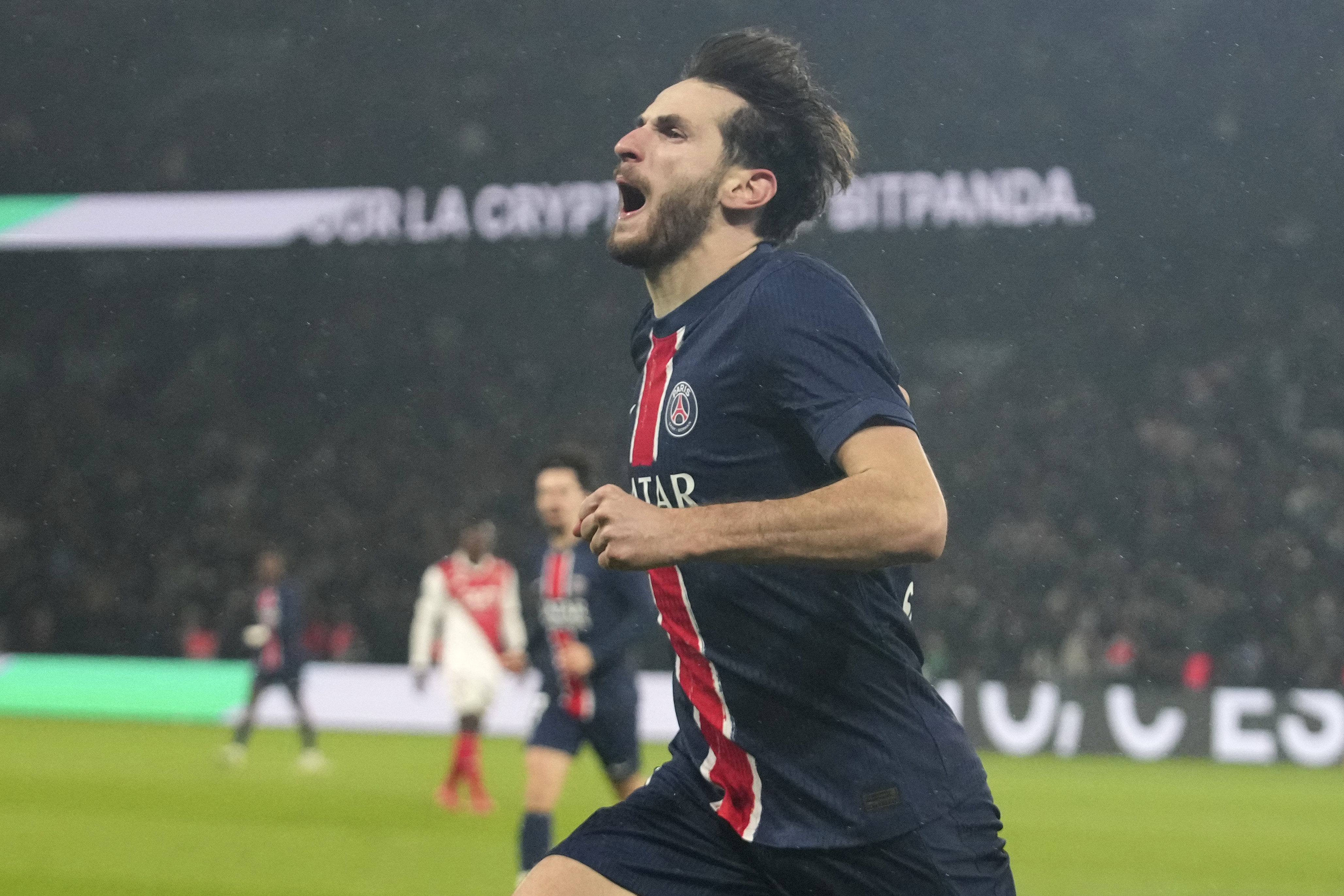 PSG's Khvicha Kvaratskhelia celebrates after scoring his sides second goal during the French League One soccer match between Paris Saint-Germain and Monaco at Parc des Princes stadium in Paris, Friday, Feb. 7, 2025.