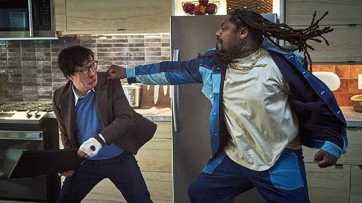 Actors Ke Huy Quan, left, and Marshawn Lynch, right, pictured in a fight scene during the 2025 movie "Love Hurts."